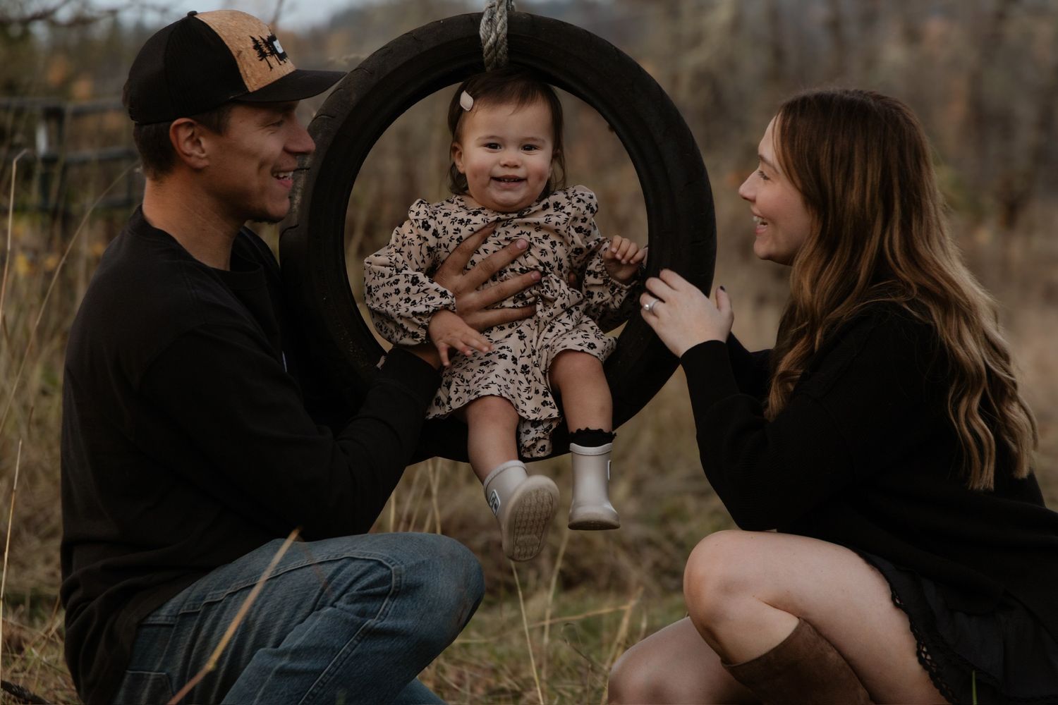 A family shares tender moments together during an outdoor autumn photo session in nature.