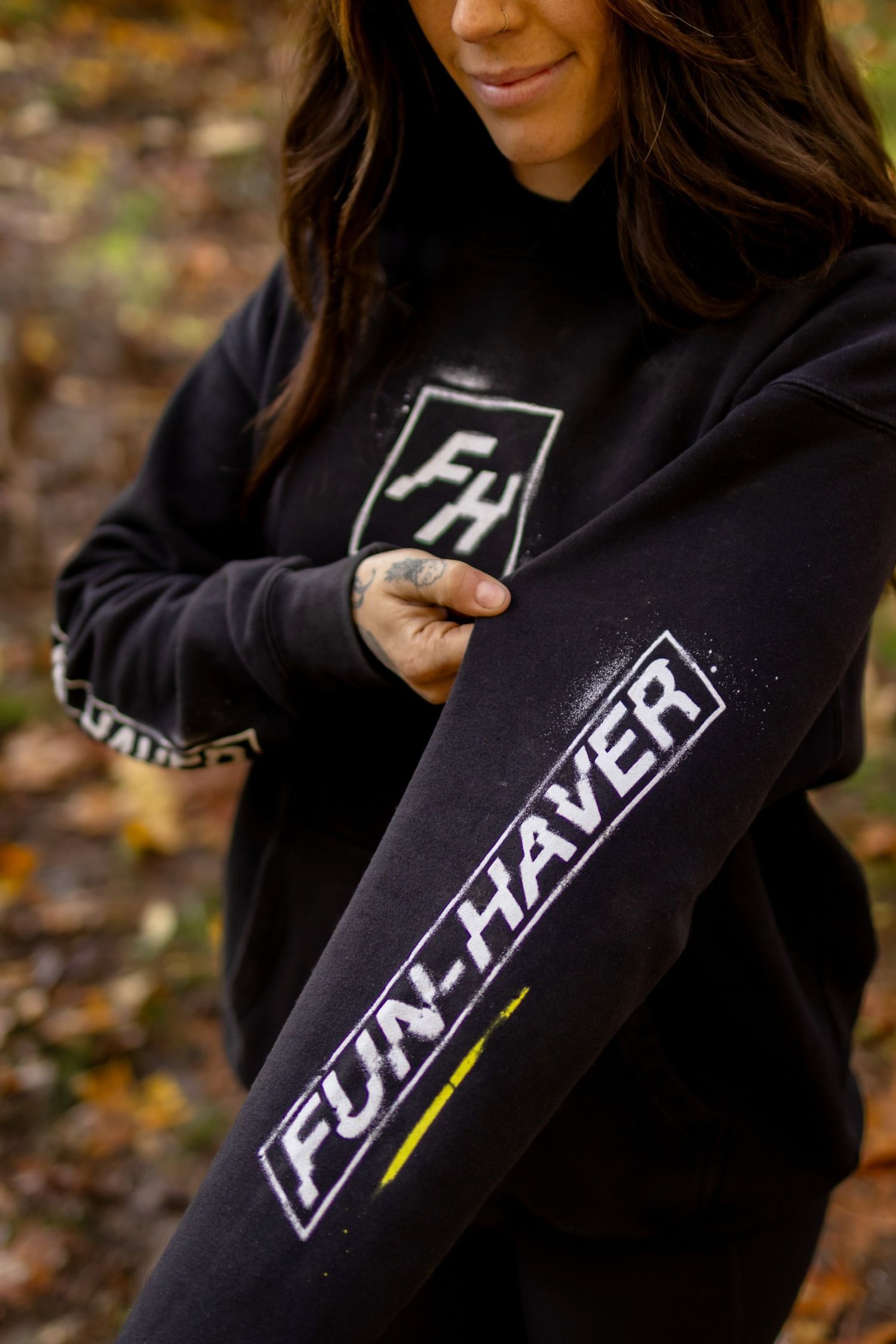 Black hooded sweatshirts with white logo designs displayed in sequence.