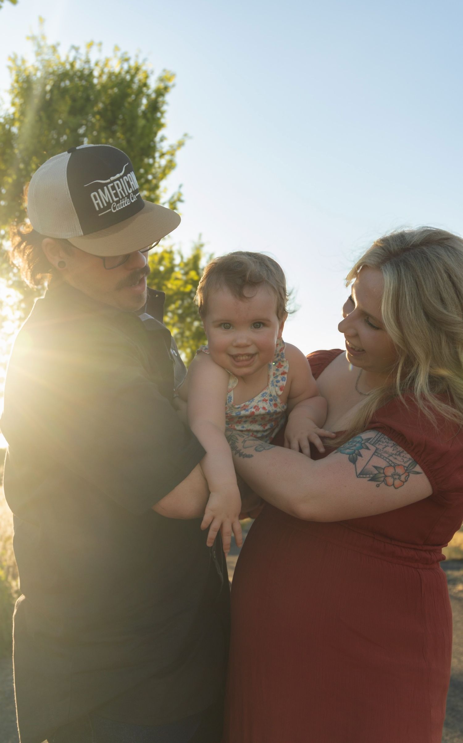 A sunlit outdoor family portrait captured during golden hour.