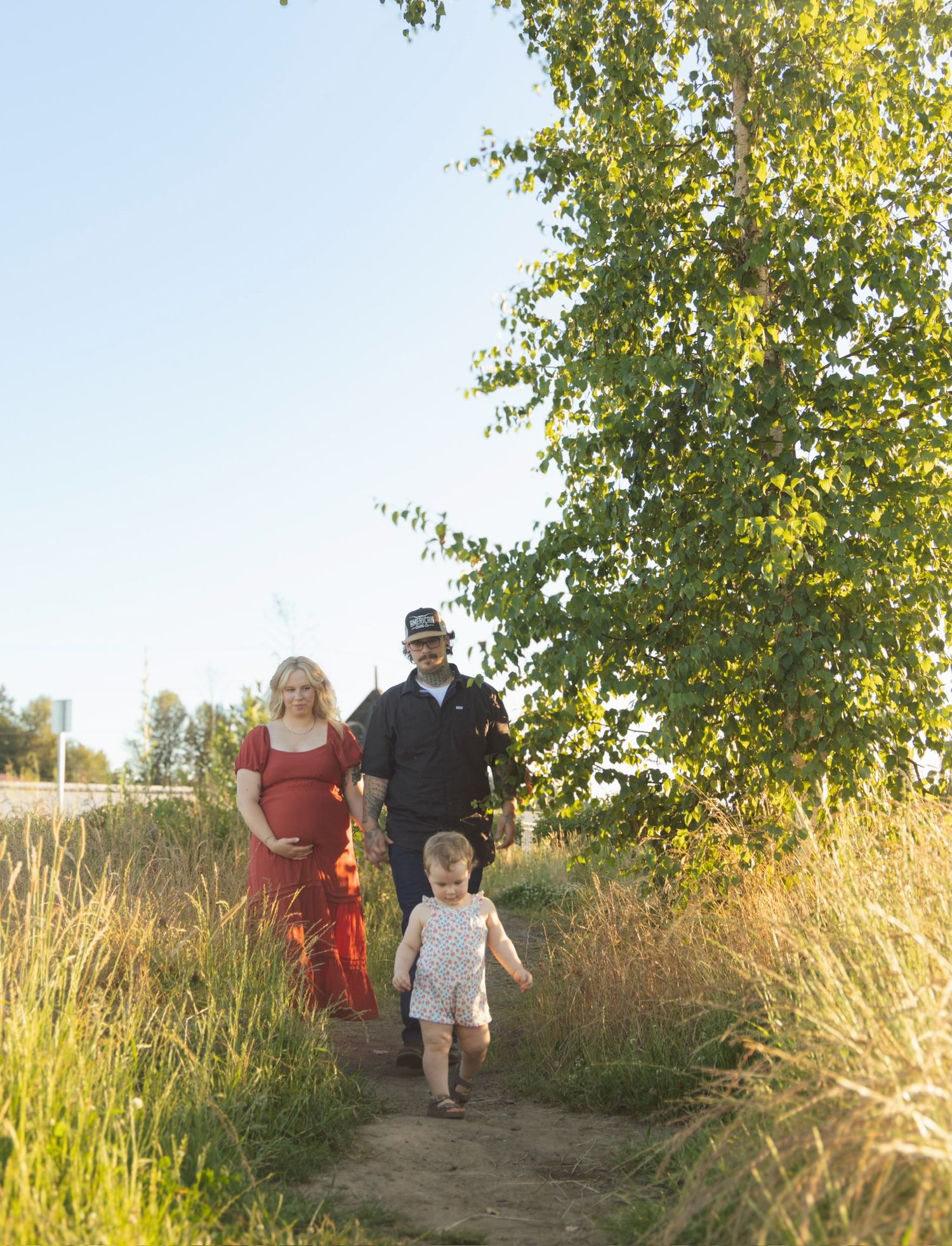 A family walking together on a nature trail during golden hour.