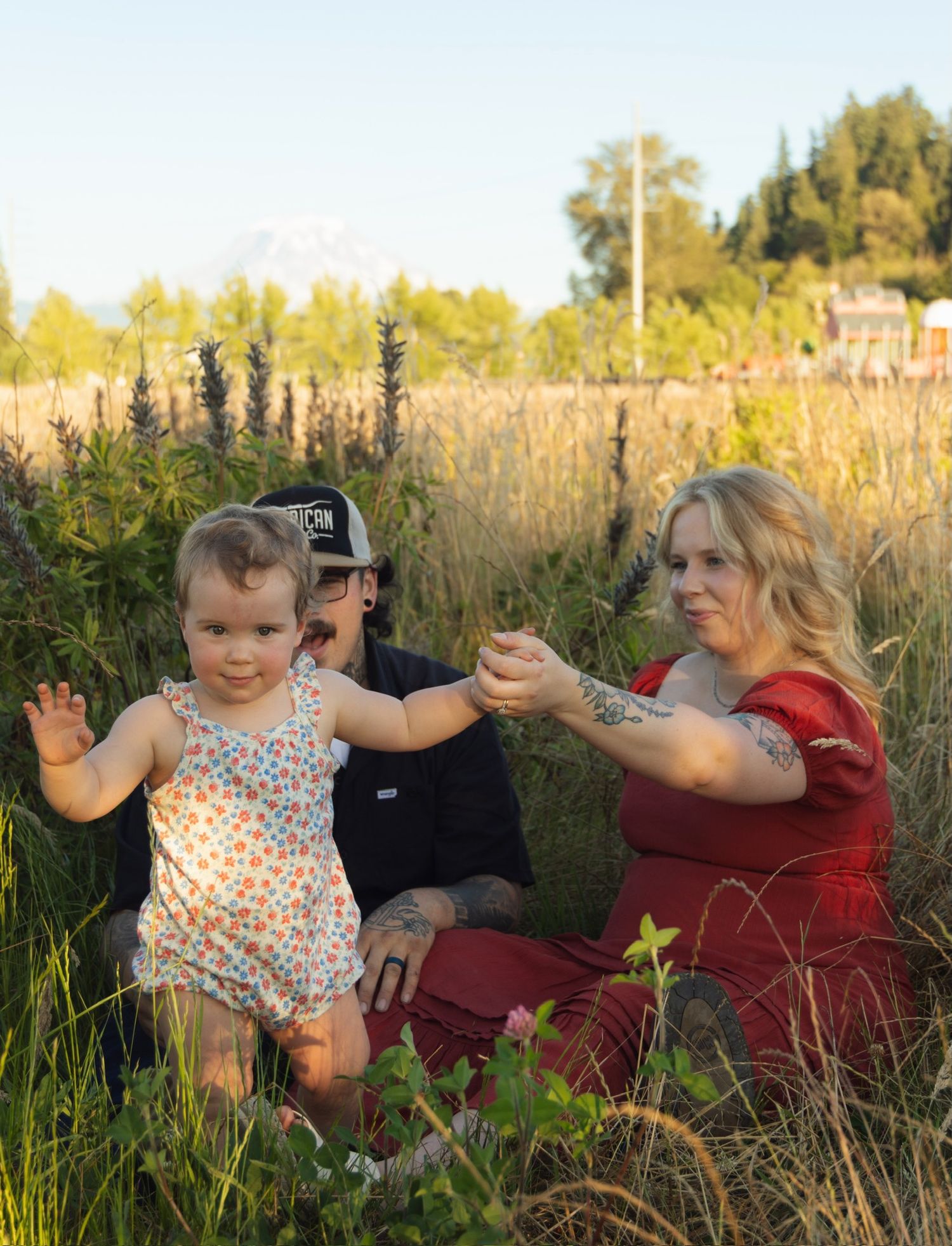 A joyful moment captured in a field during sunset.