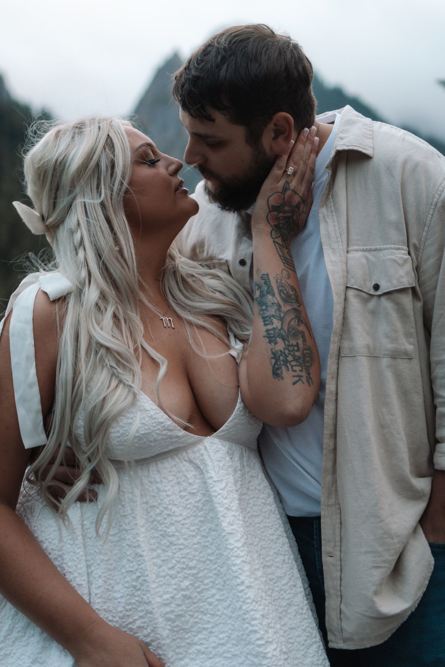 Intimate couple's photoshoot featuring light and dark contrasting outfits.