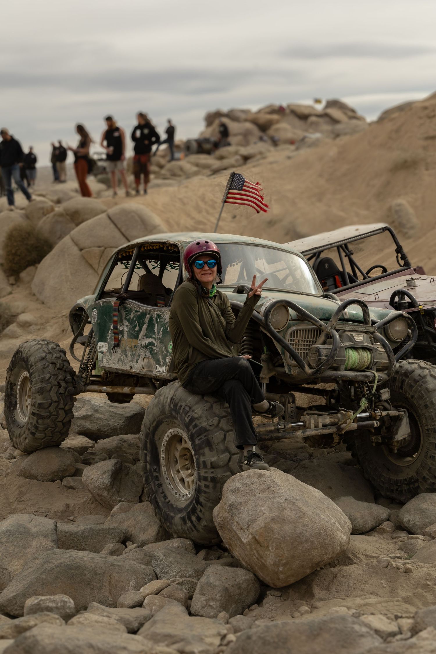 Remote control rock crawler vehicles navigate challenging rocky terrain during an outdoor RC competition course.