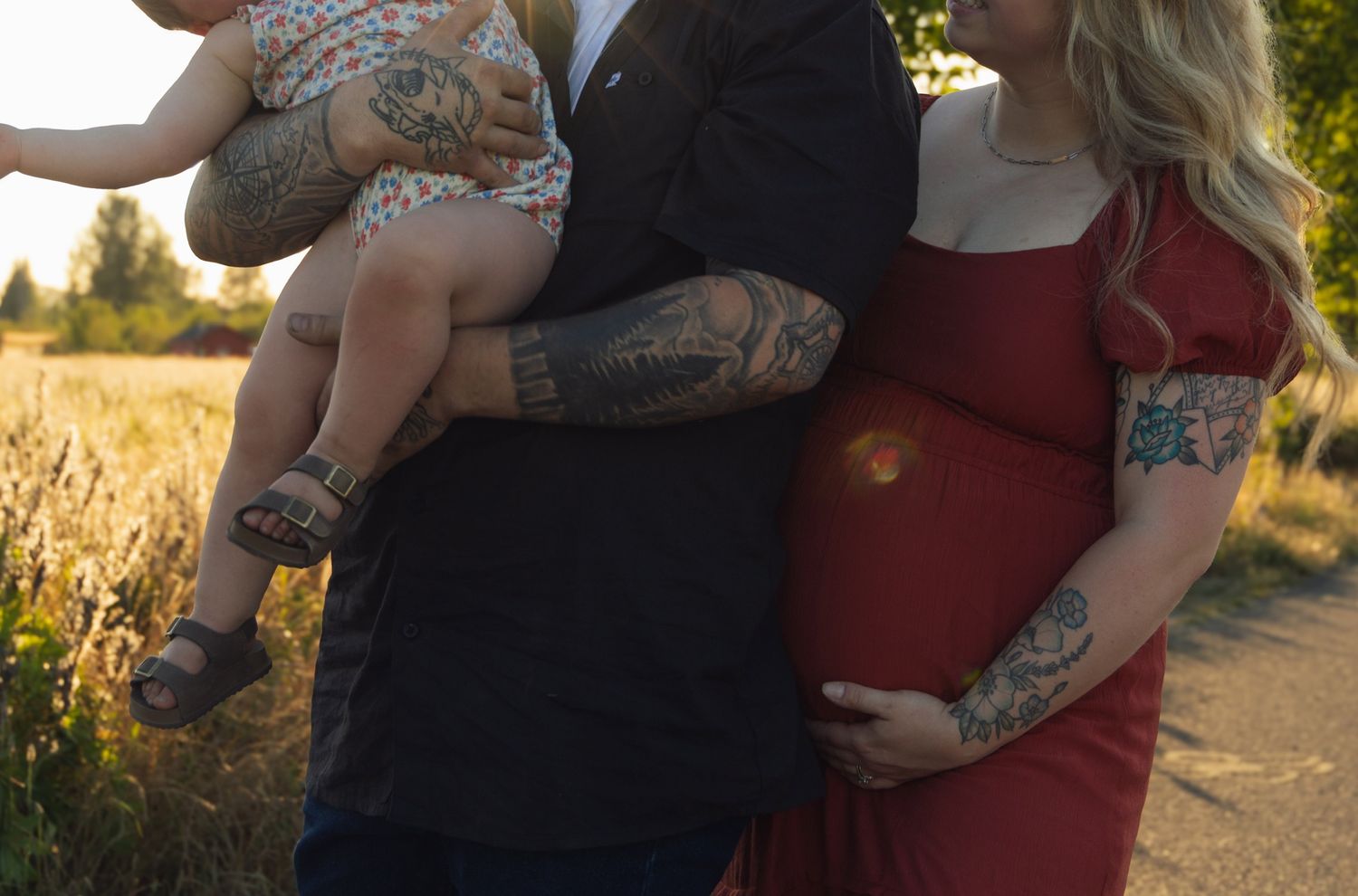A family moment captured in golden sunlight on a rural path.