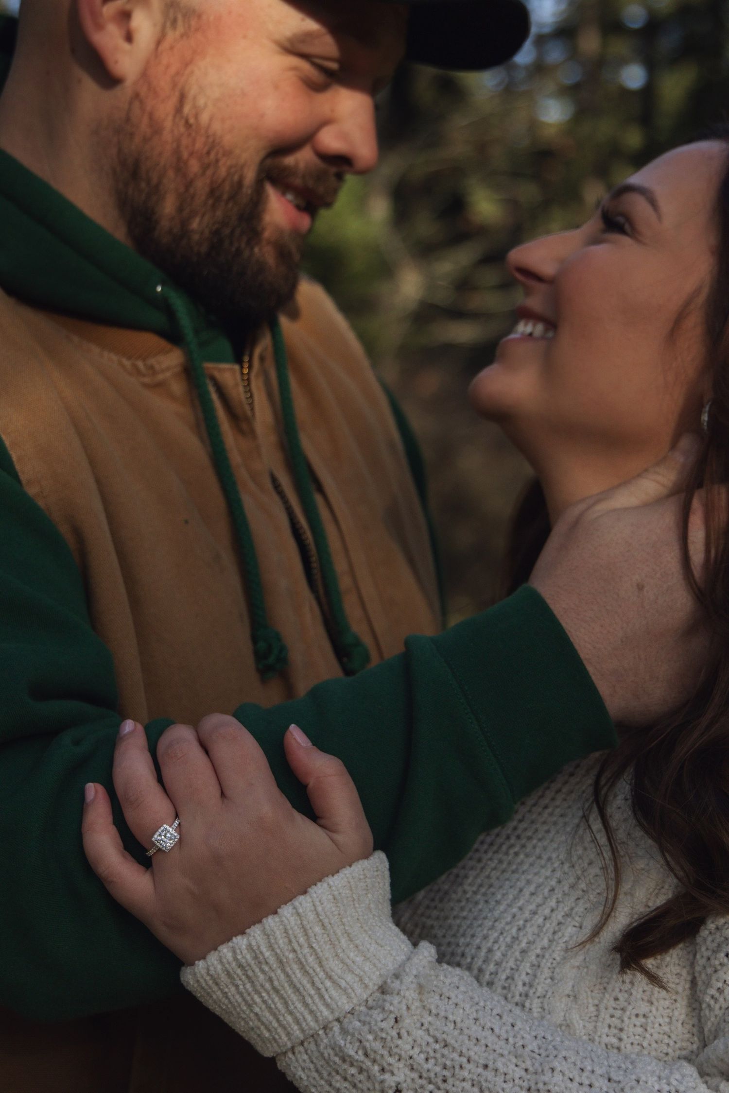 Couple in casual winter attire sharing an intimate moment outdoors.