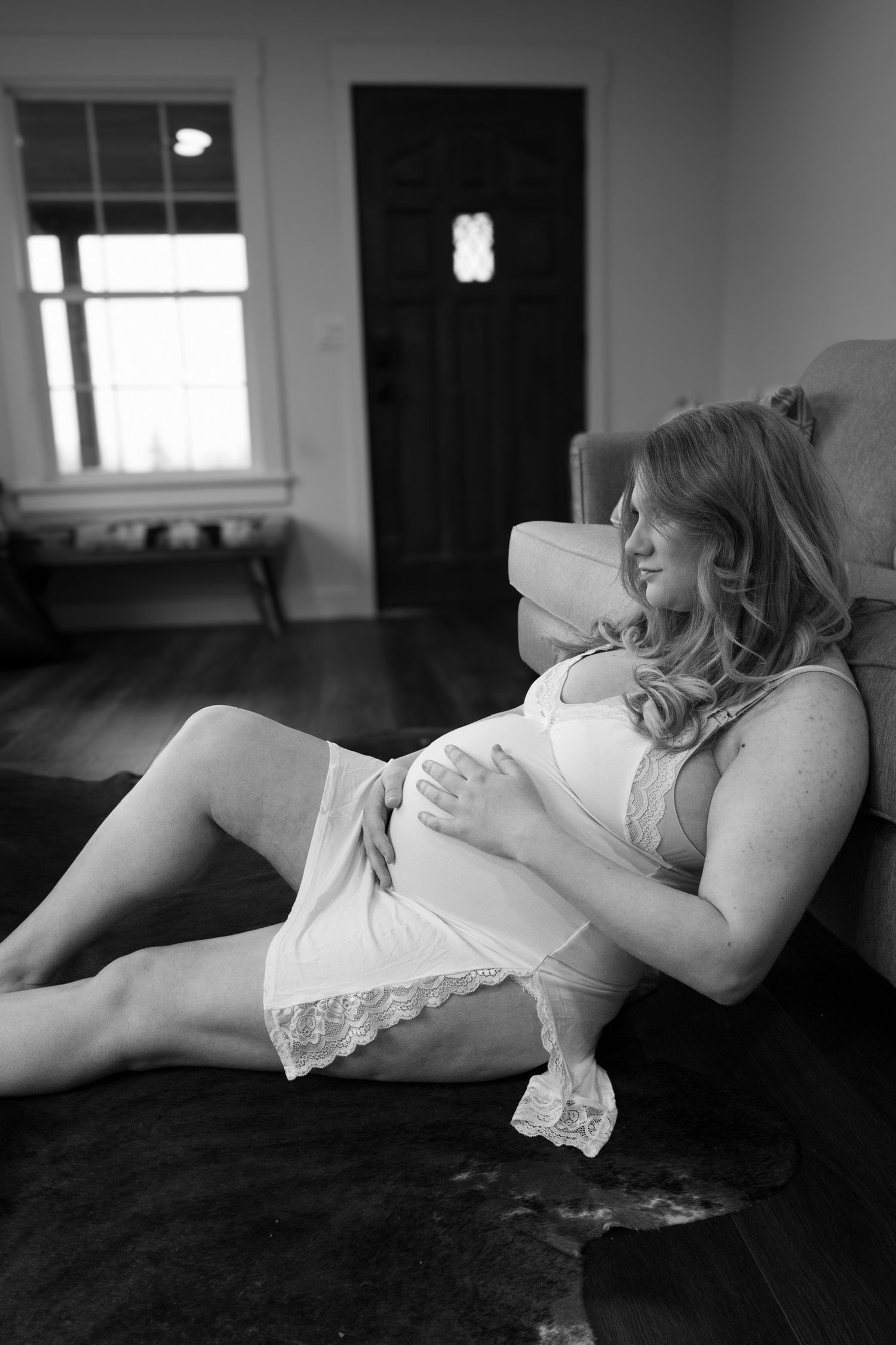 Intimate black and white boudoir photography session on bed.