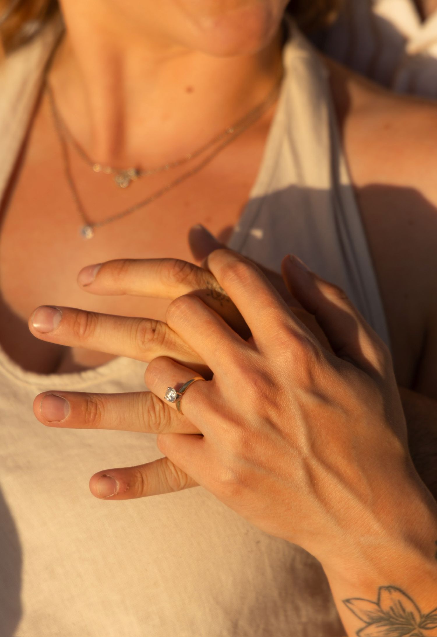 Close-up sequence of hands exchanging rings during an outdoor ceremony.