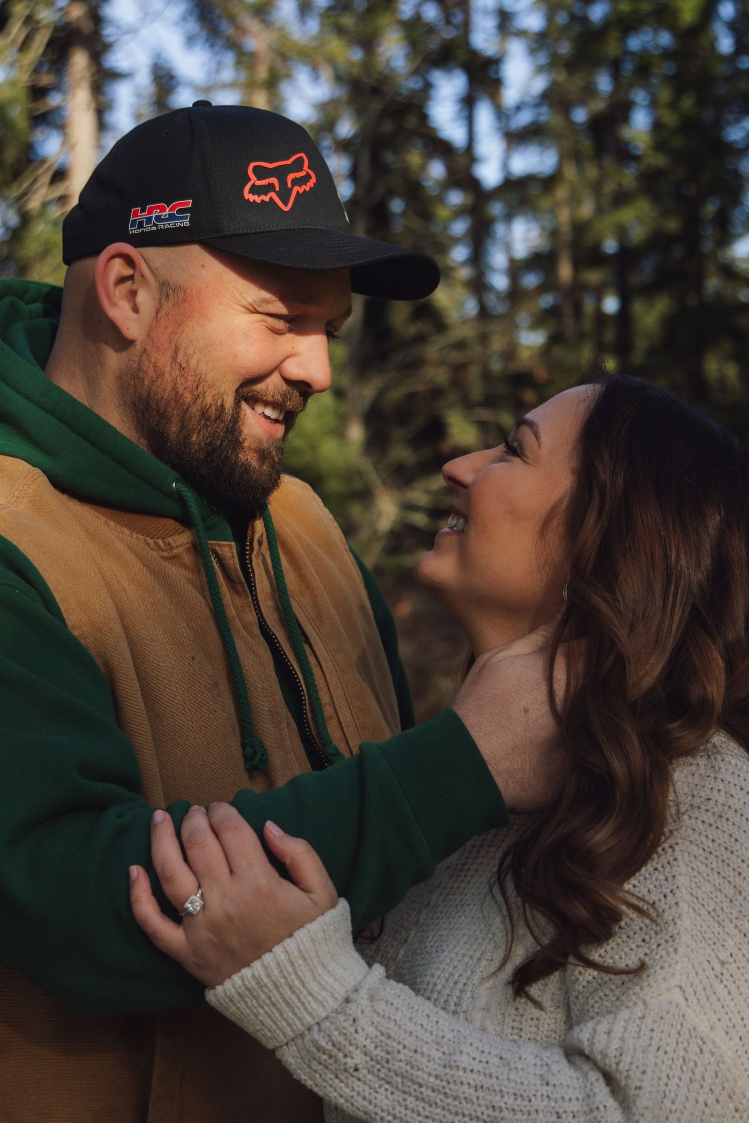 Couple sharing an intimate moment outdoors wearing casual winter clothing.