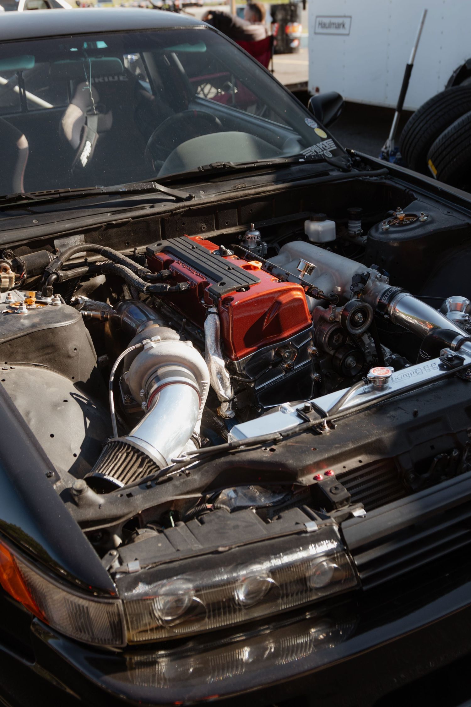 Close-up view of a modified car engine bay showing performance parts and turbo components.