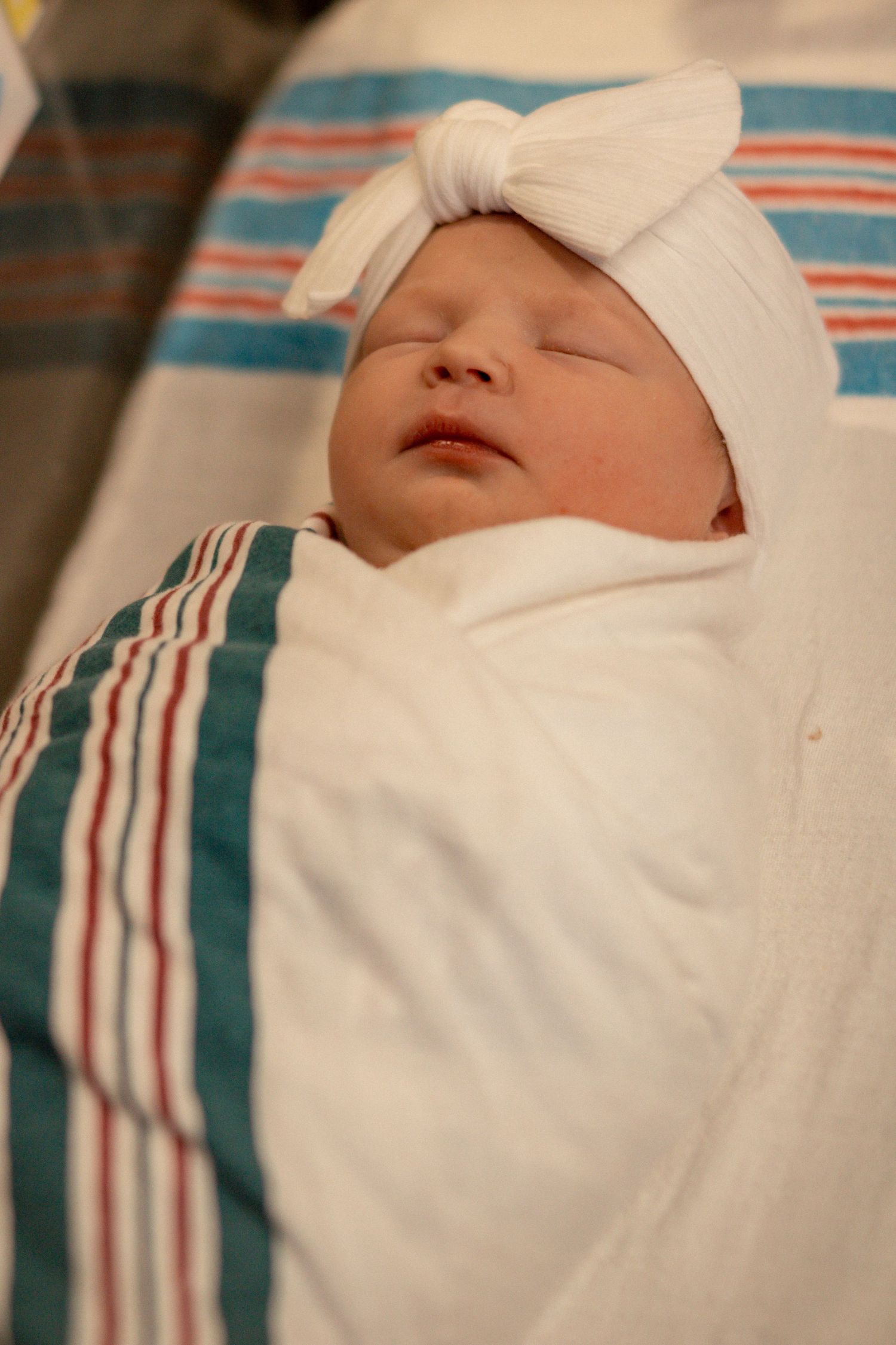 Newborn baby wrapped in hospital blanket during Fresh 48 session