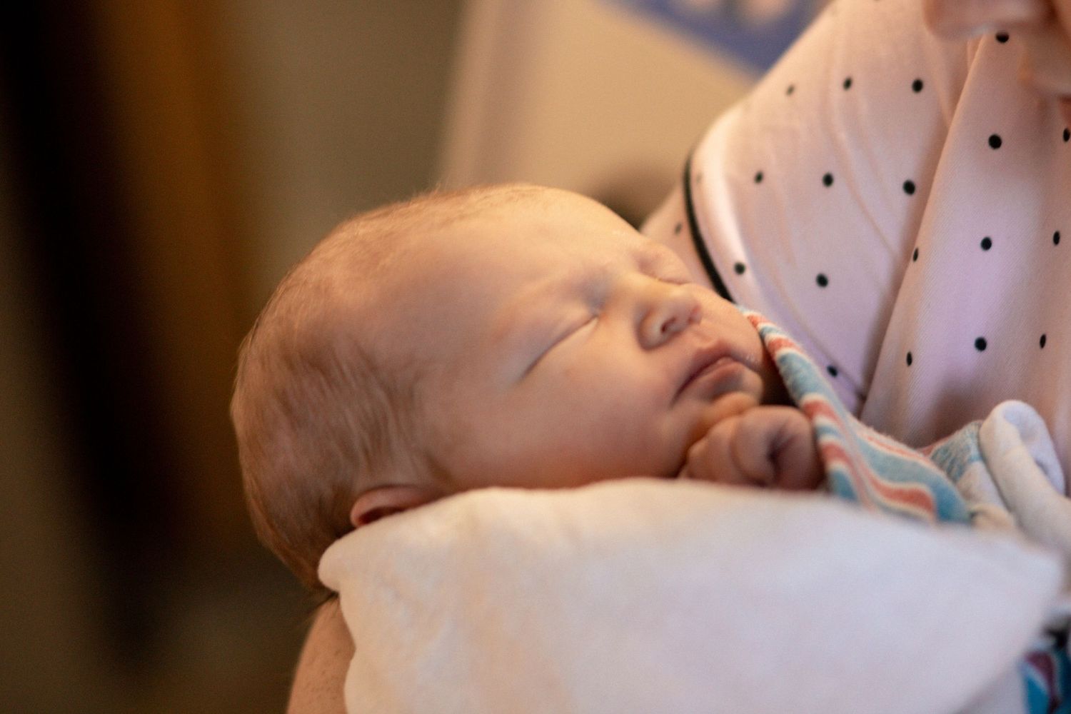 Newborn baby wrapped in hospital blanket during Fresh 48 session
