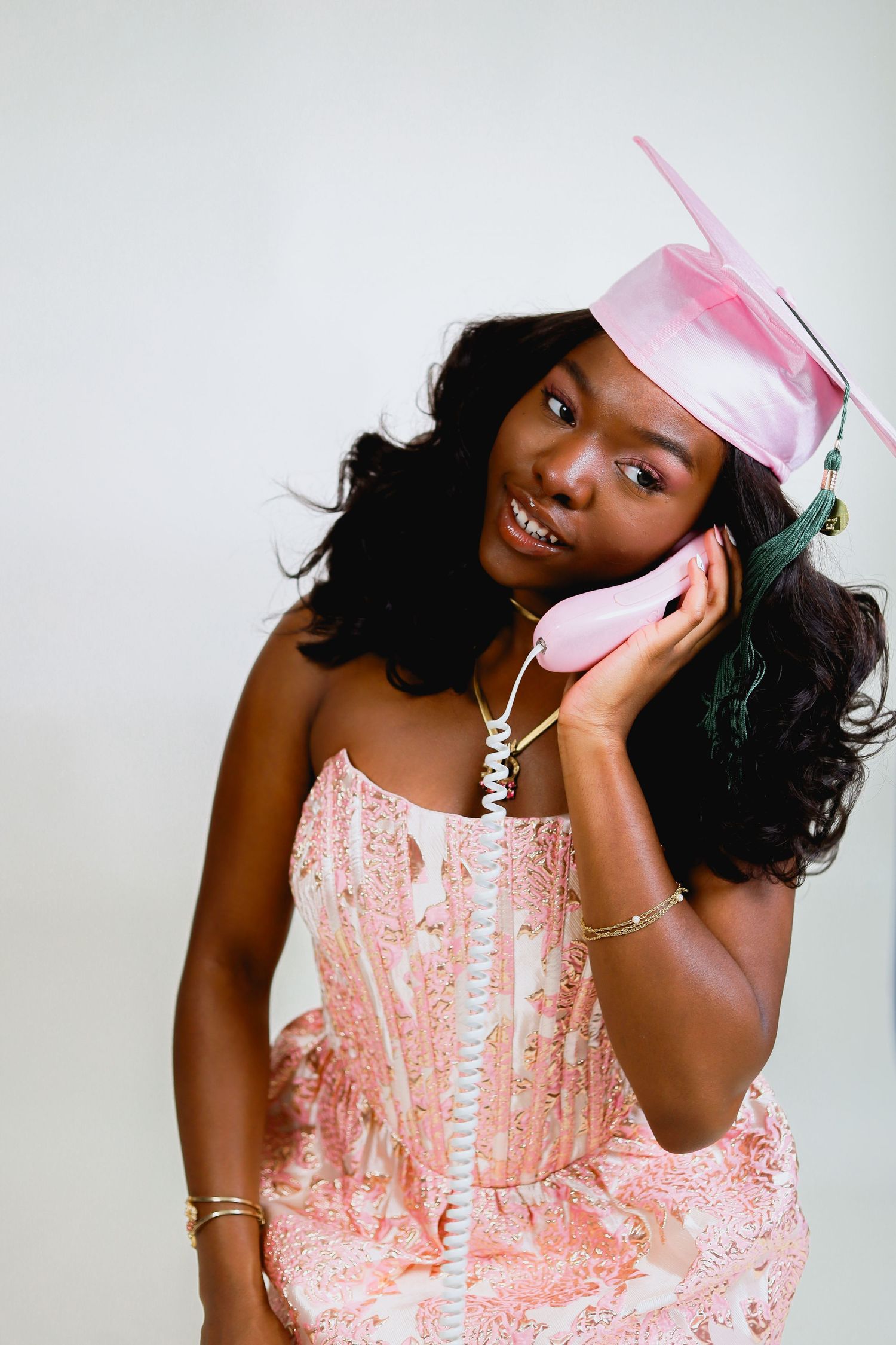 Vintage-inspired photo shoot with pink dress and retro telephone accessories.
