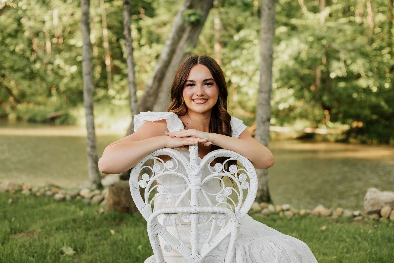 Elegant outdoor portraits featuring a decorative white chair in a garden setting.