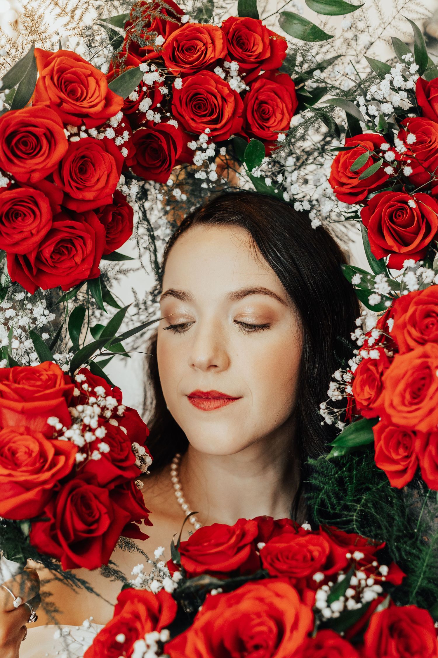 Beautiful floral portrait surrounded by red roses and baby's breath.