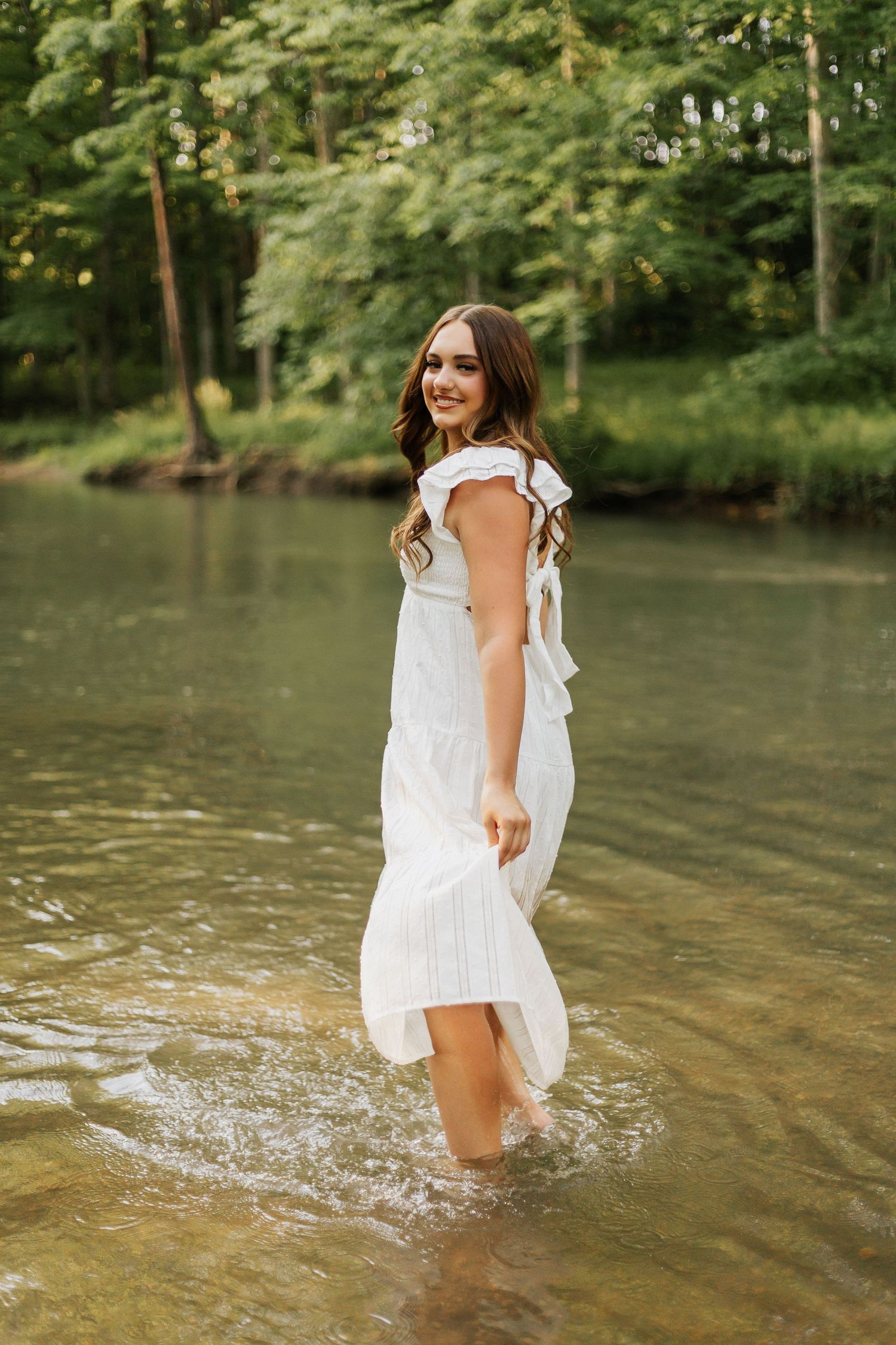 Splashing water creates magical moments during a summer creek portrait session.