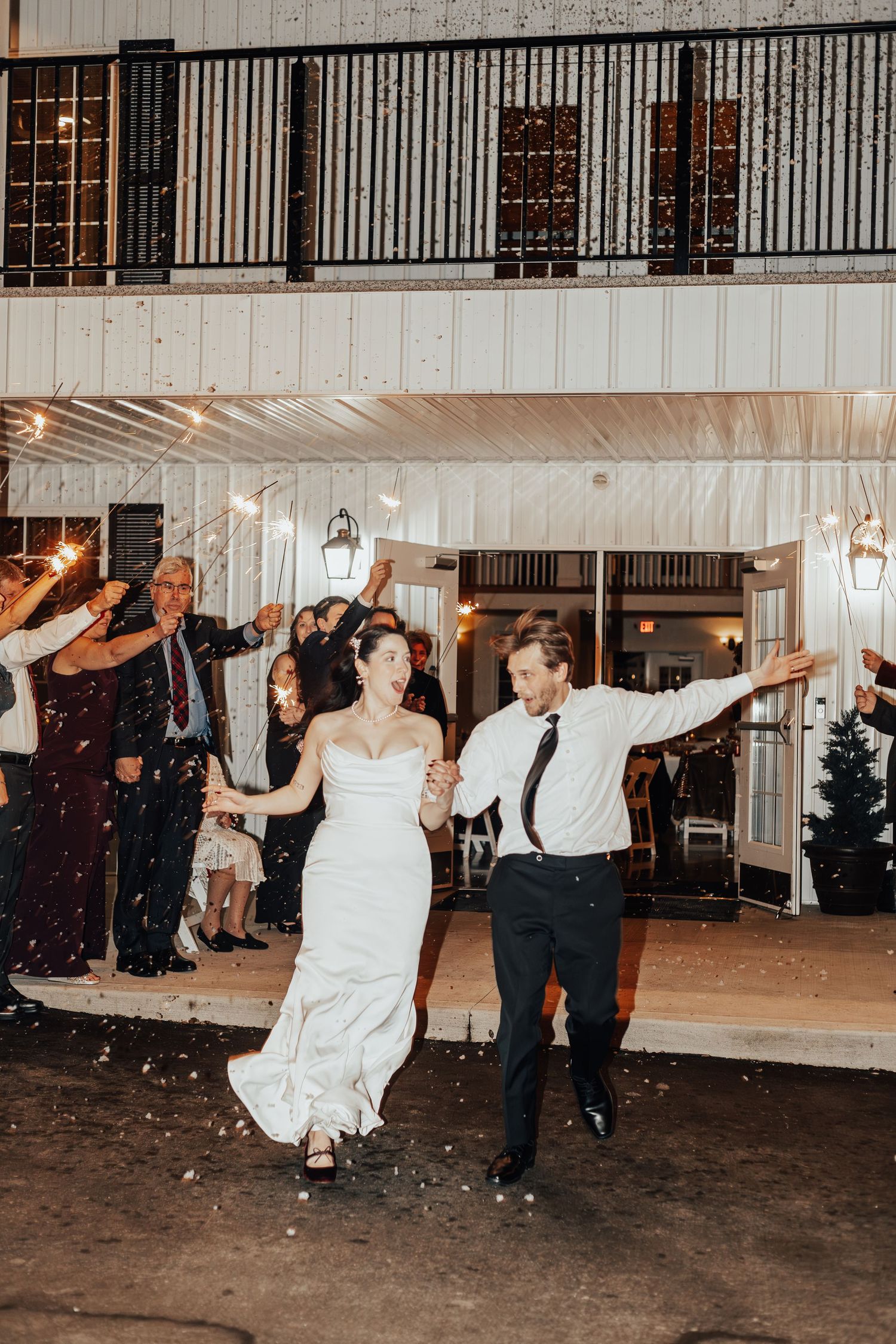Energetic wedding reception dance floor moments captured in black and white.