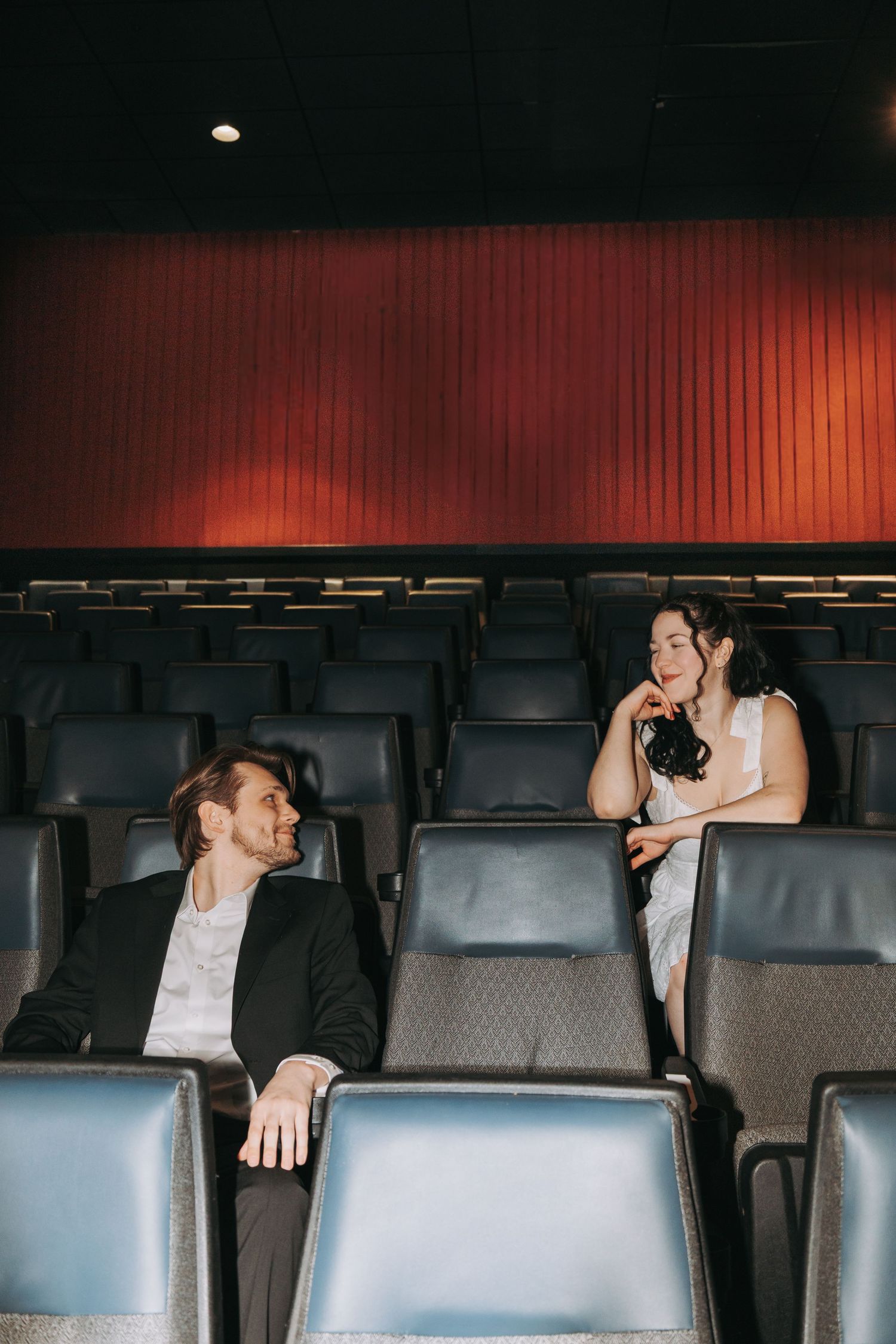 Empty theater seats shown in a cinematic composition with dramatic lighting.