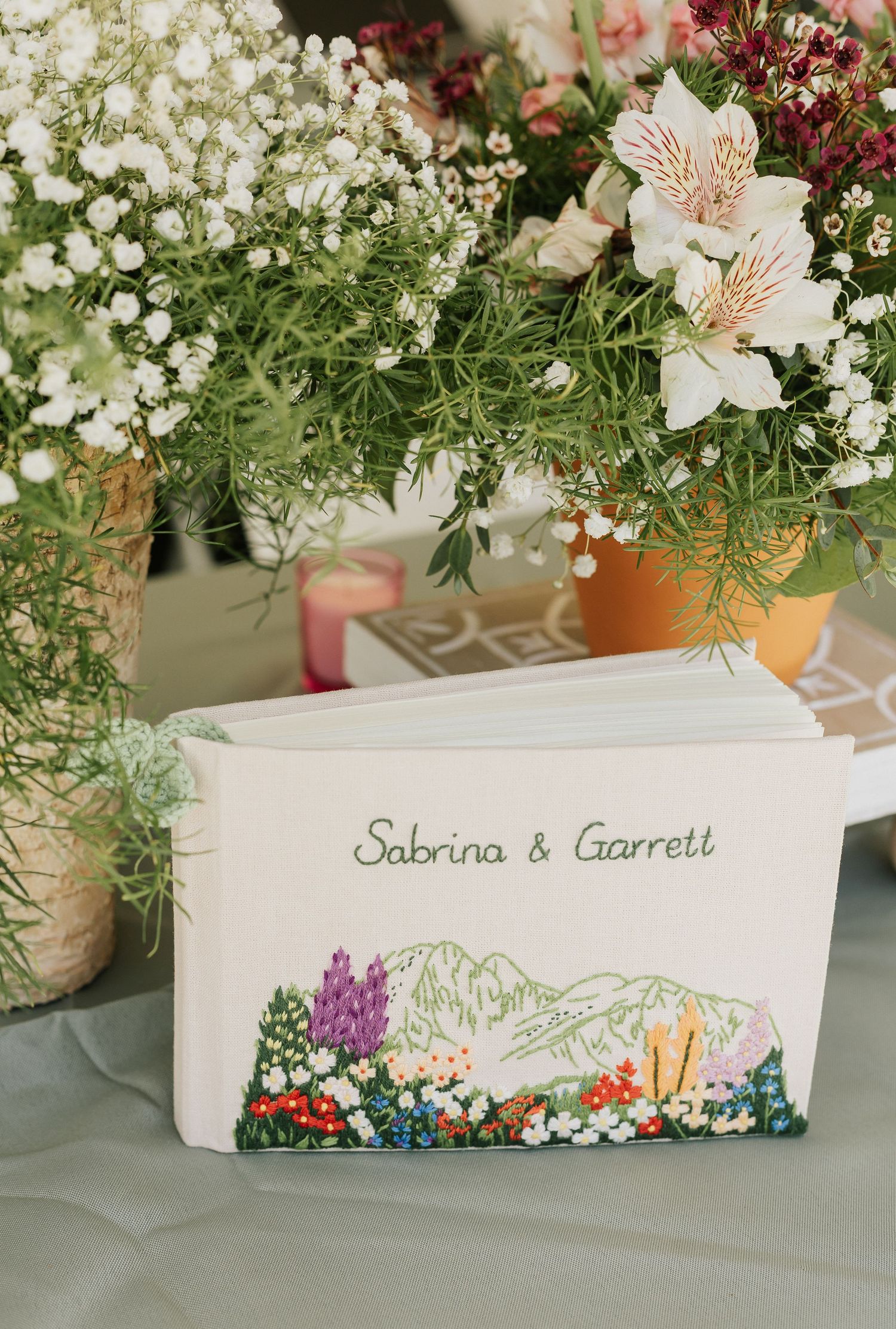 Decorative place cards with floral designs and names displayed on a light gray surface.