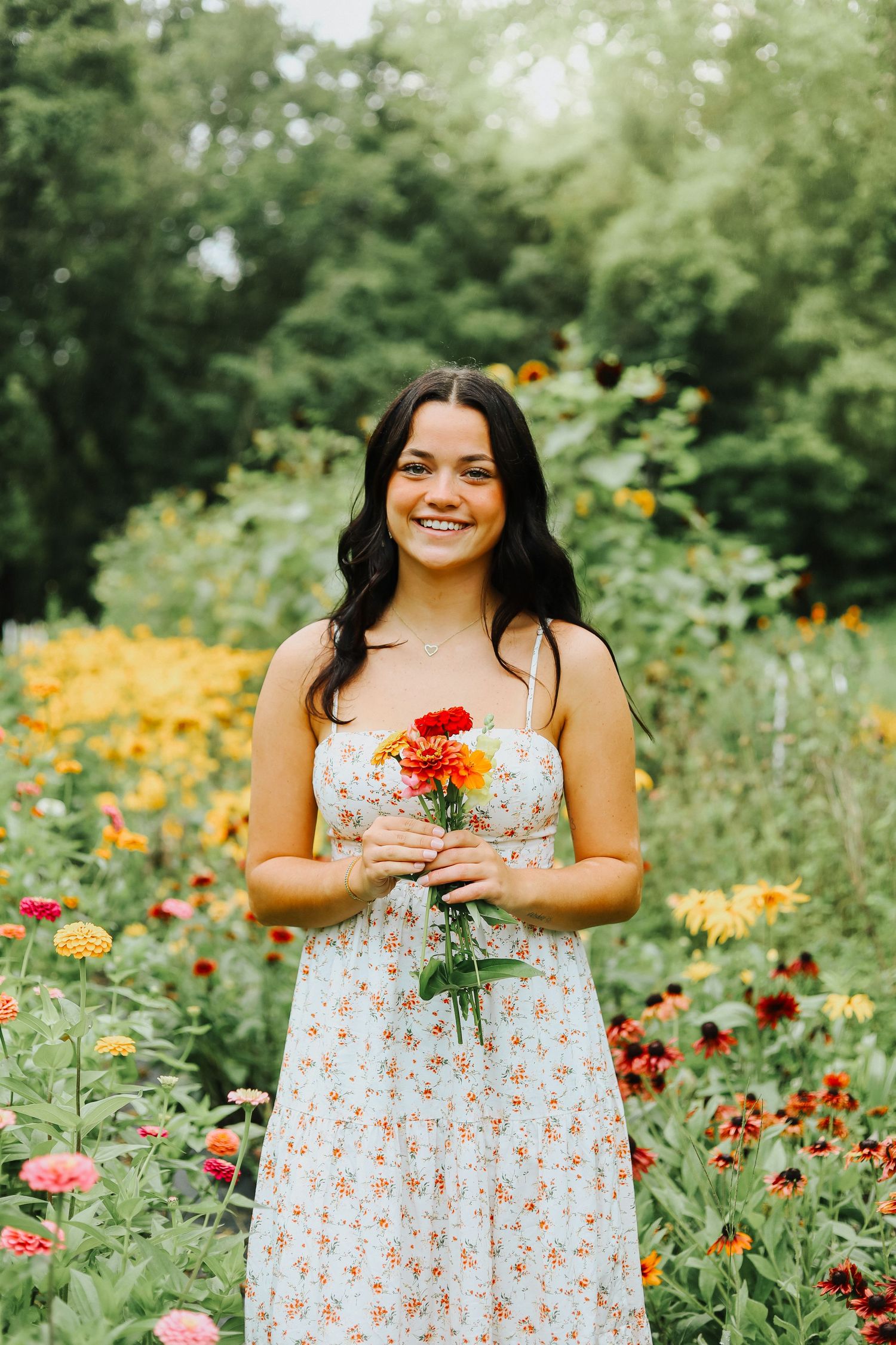 Colorful flower garden with zinnia and marigold blooms in summer sunlight.