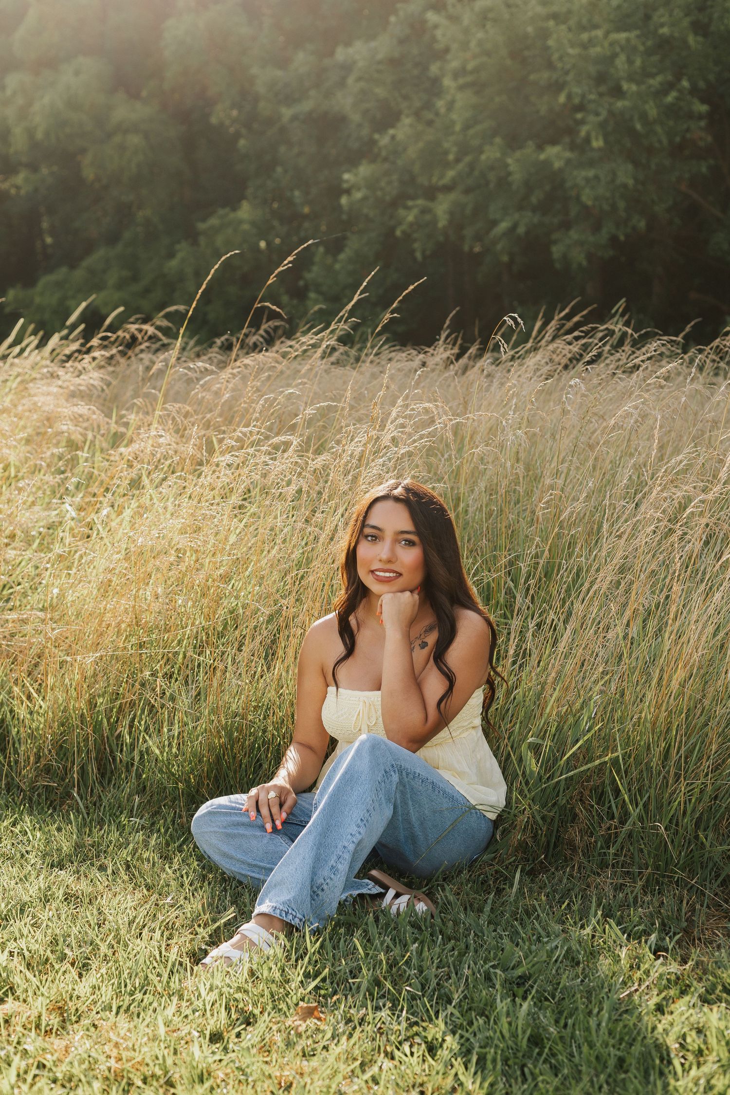 Natural light portraits in tall golden grass during sunset.