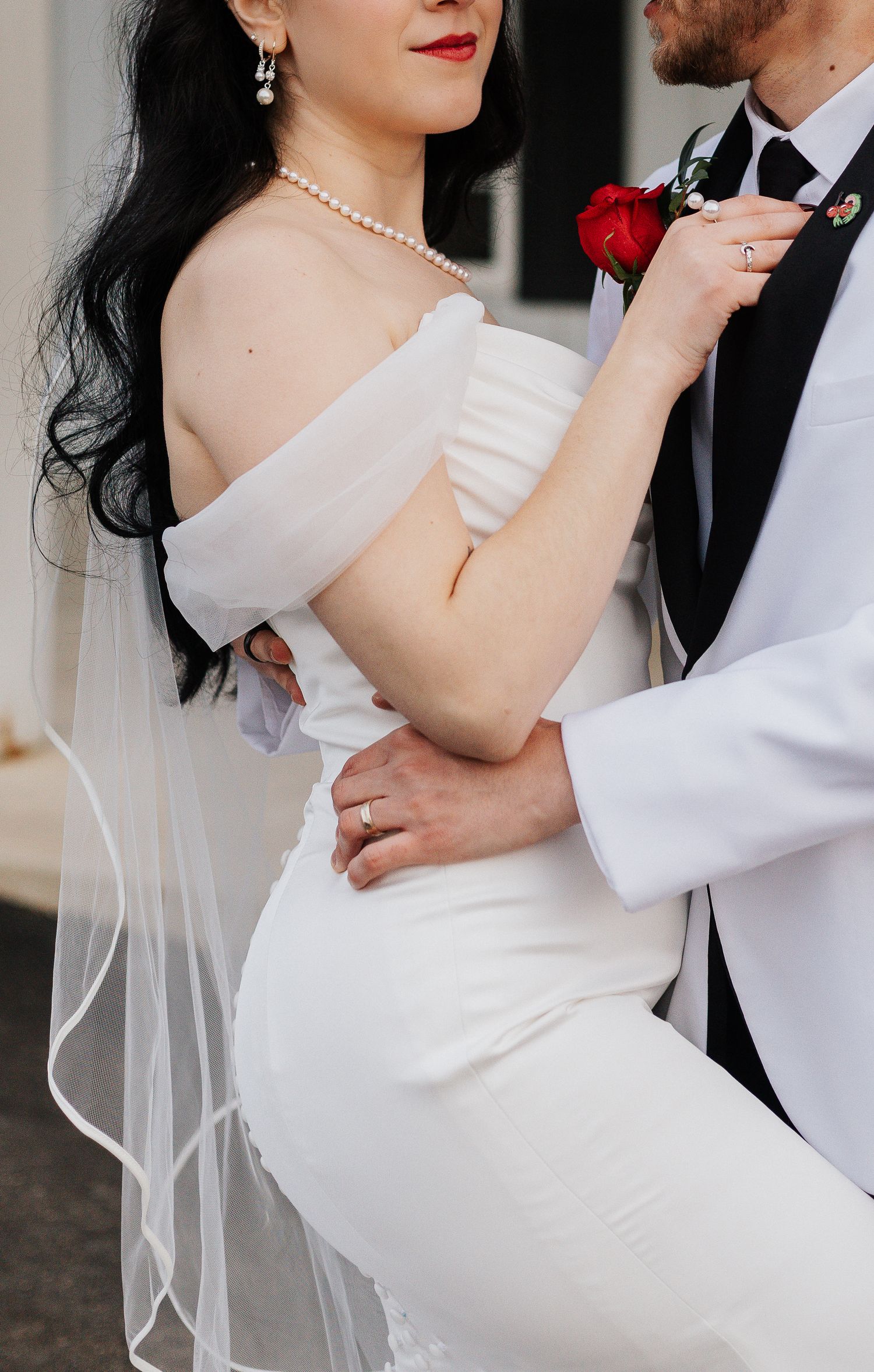 Romantic wedding couple poses showing intimate moments in classic black and white attire.