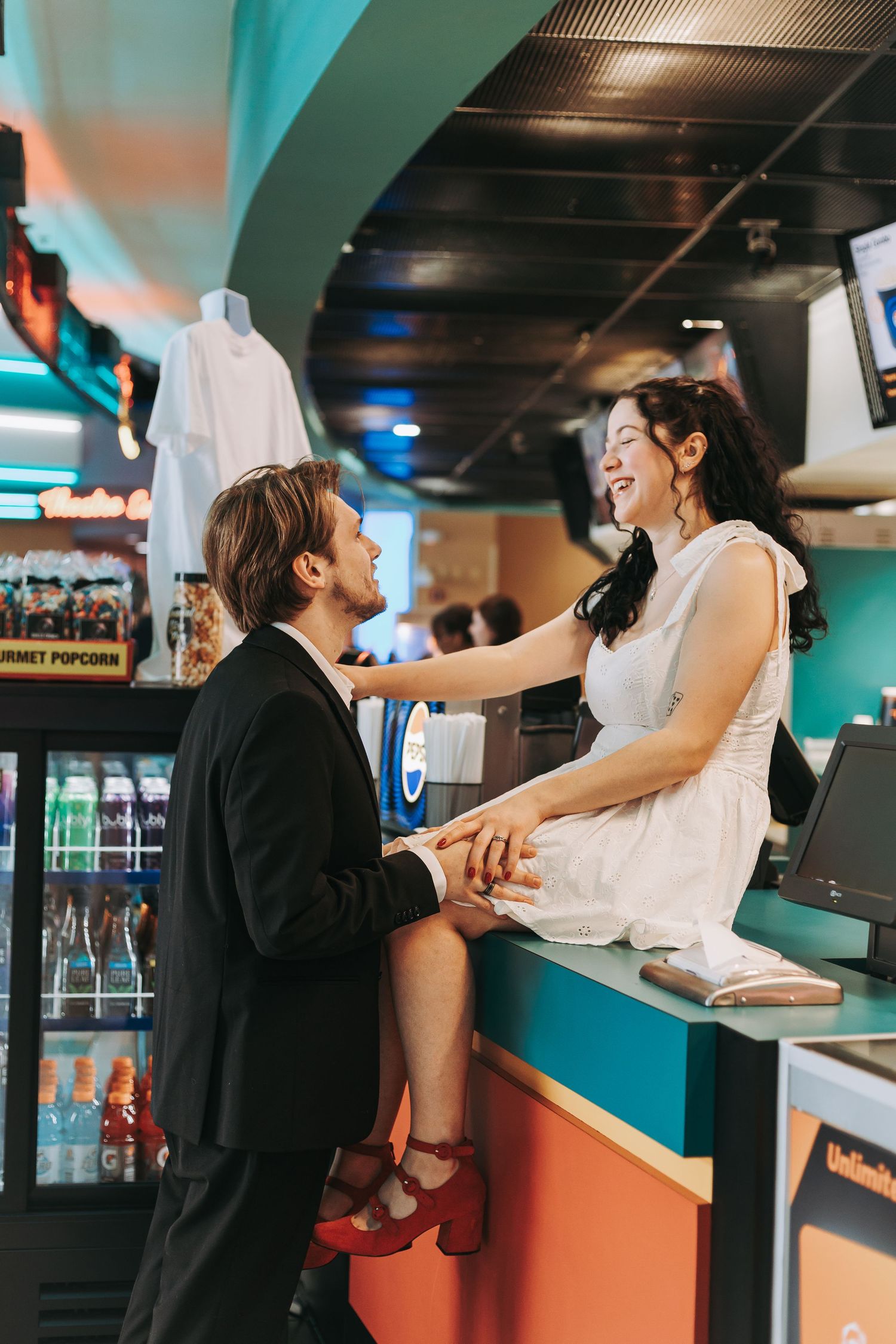 A lively scene at a retro-style diner counter with turquoise walls.