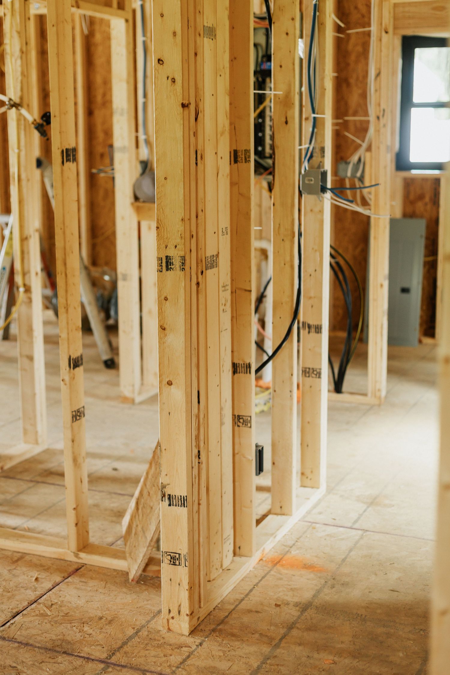 Interior wooden wall framing and studs in new residential construction.