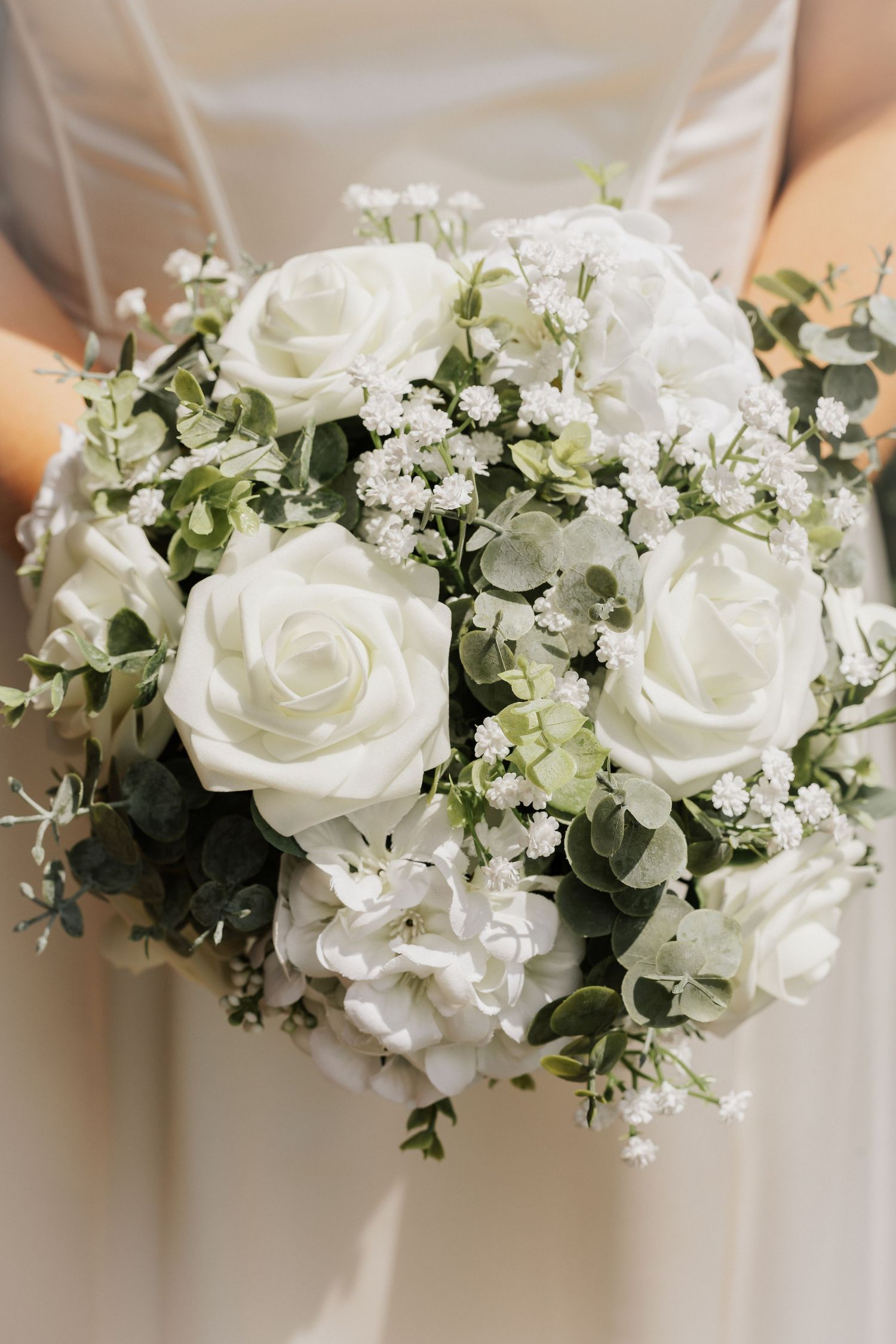 Elegant white rose and baby's breath floral arrangement detail shot.