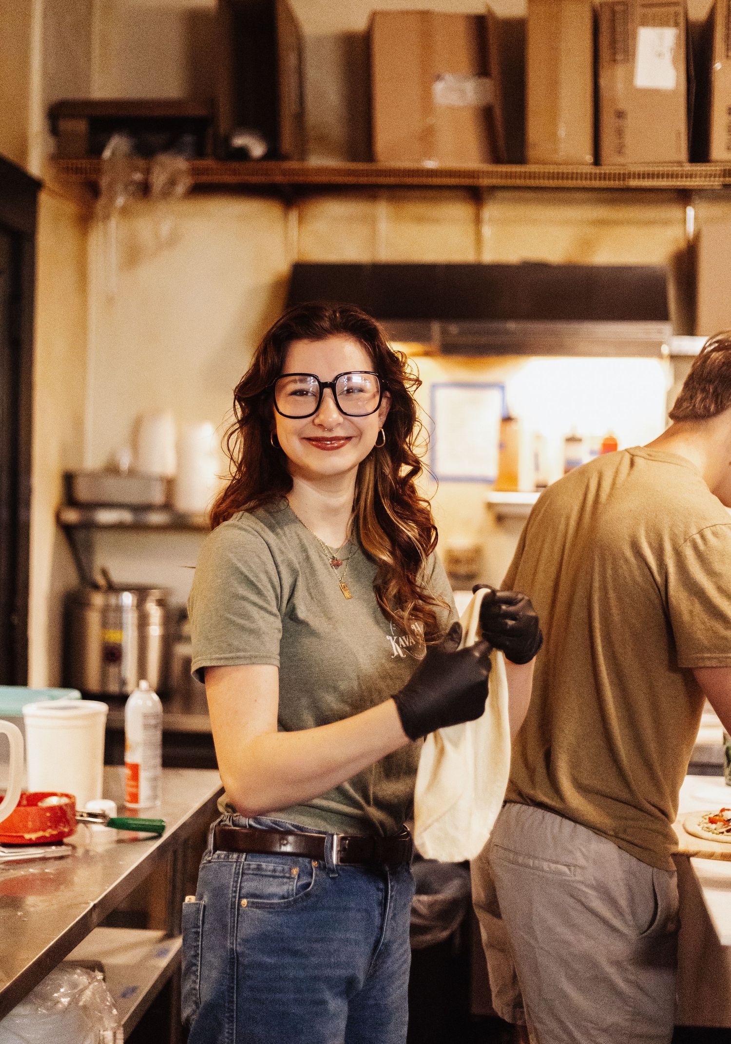 Restaurant staff preparing food in commercial kitchen.