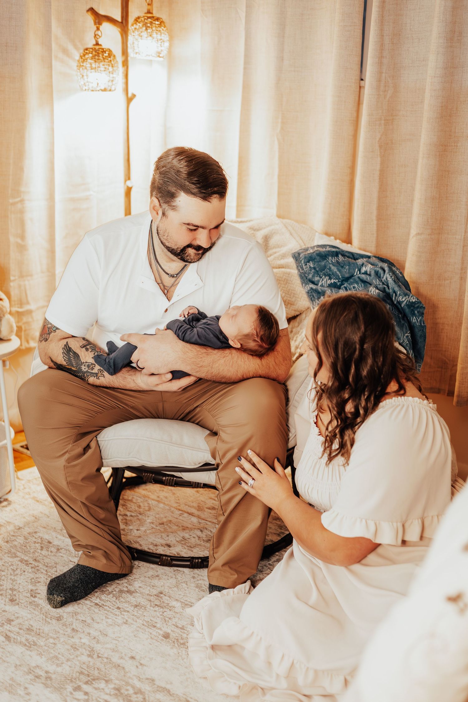 Family sharing an intimate moment together on a carpeted floor with curtains in the background.