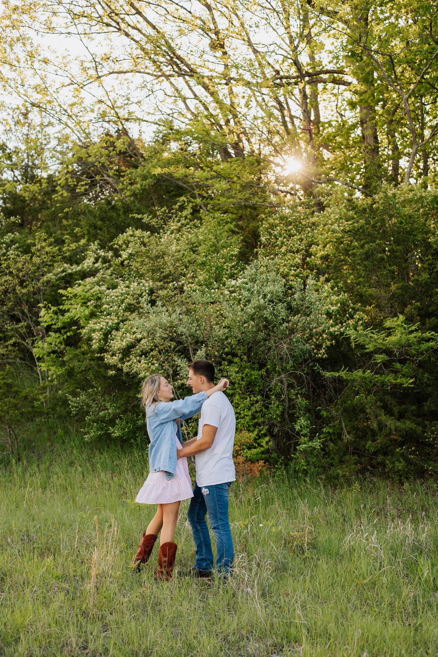 A sunny outdoor scene in a grassy field with trees in the background.