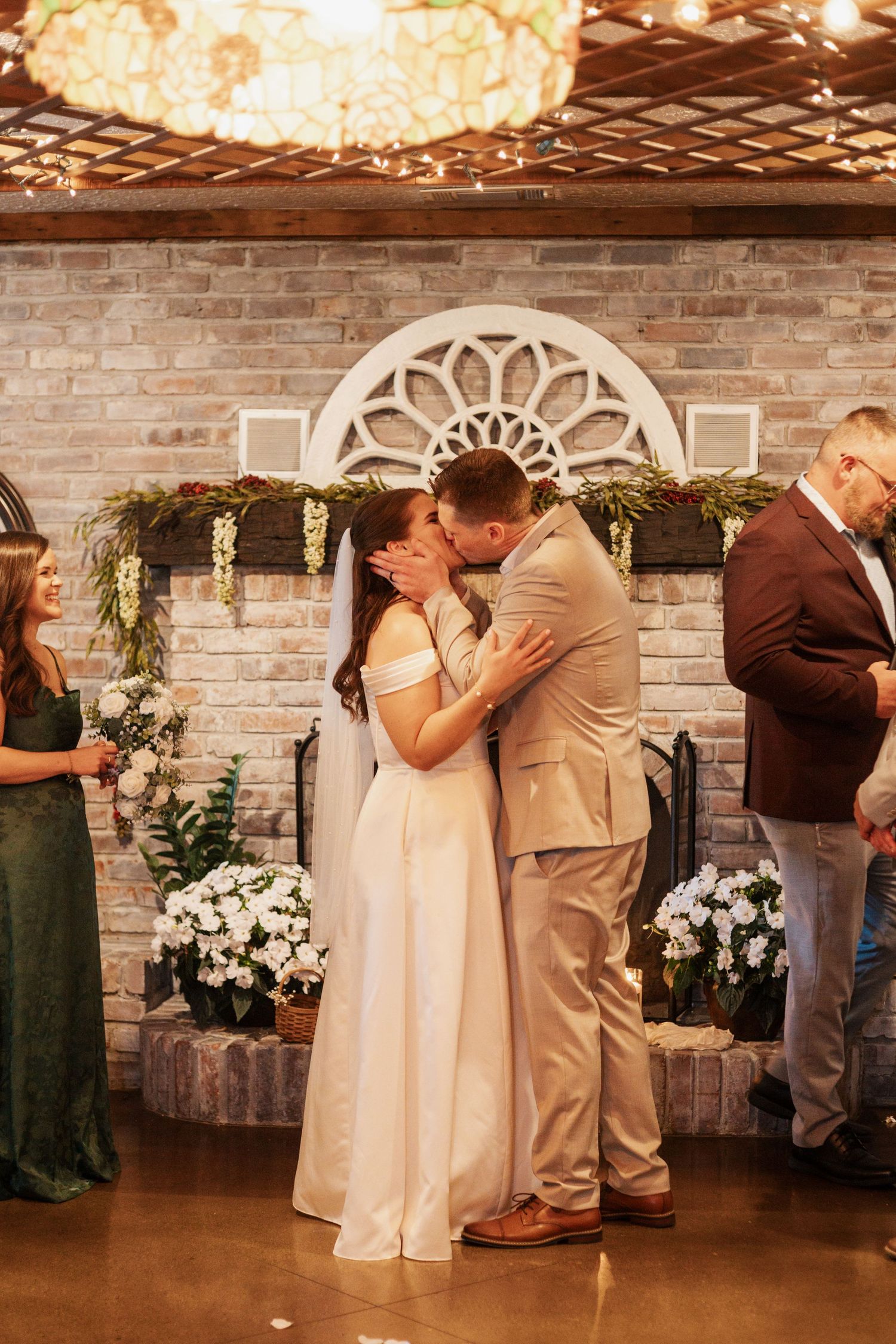 Romantic wedding dance sequence showing couples dancing in an elegant brick-walled venue with twinkling lights.