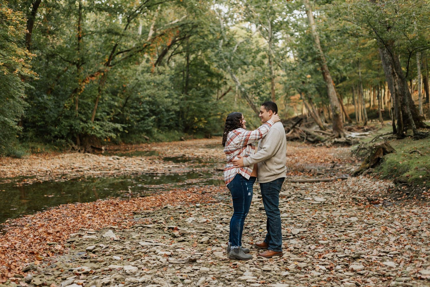 Series of romantic moments captured in a wooded setting during autumn.