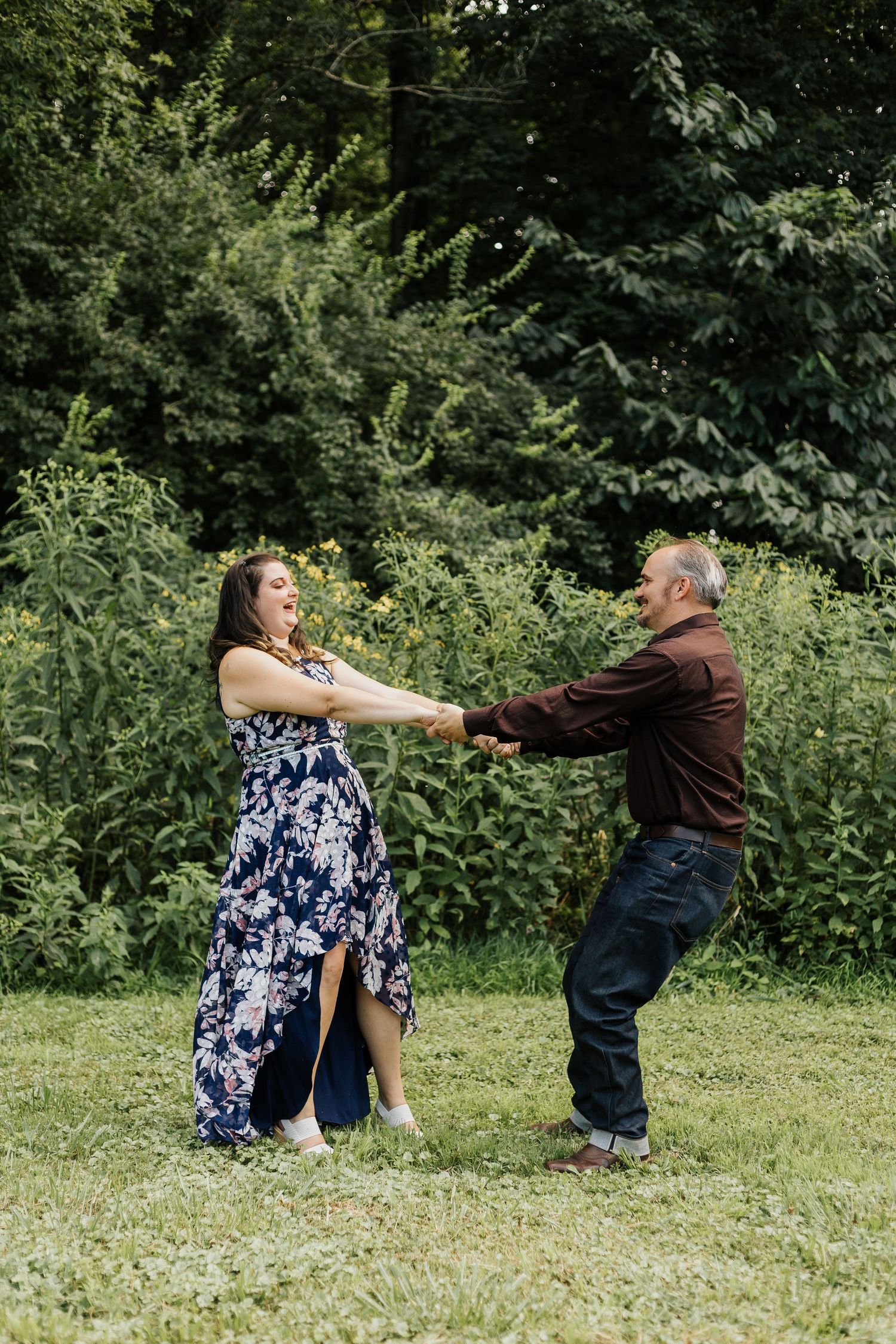Playful dance moves in a sunny garden with green foliage backdrop.