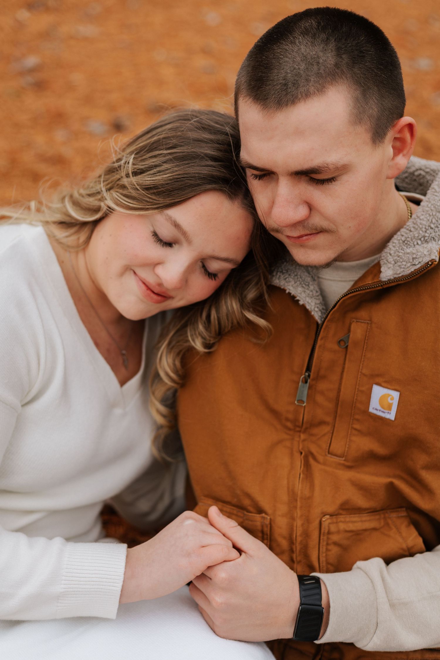 Intimate close-up shots of a couple in casual autumn attire sharing tender moments.