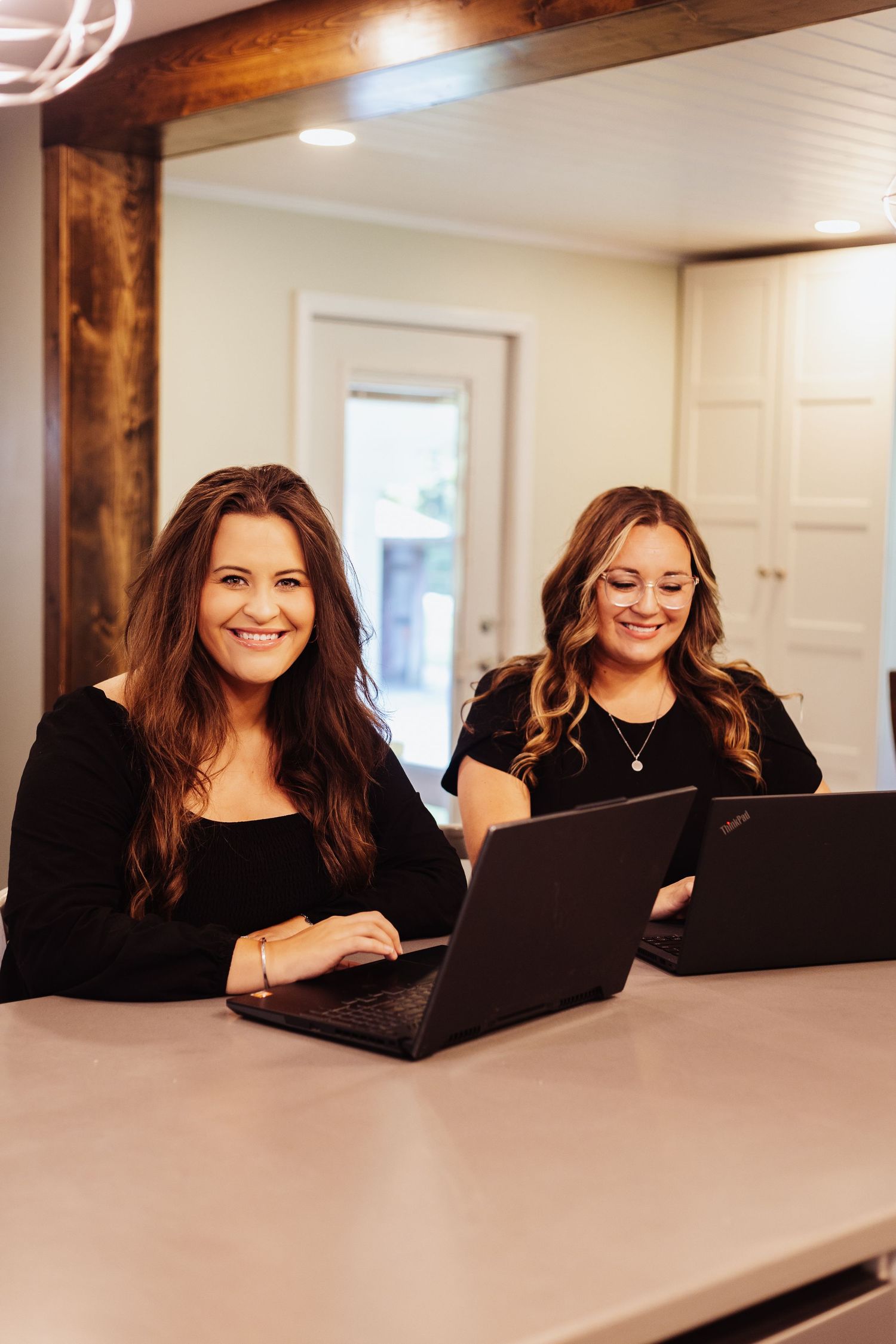 Series of casual workplace photos at a white desk with wooden beams.