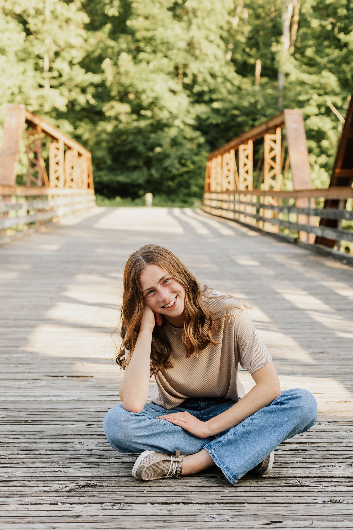 Casual portraits on a wooden boardwalk surrounded by lush summer greenery.