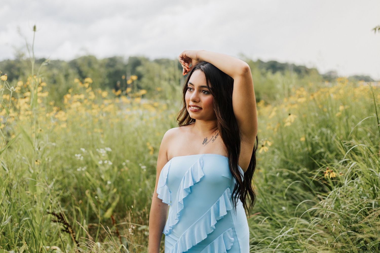 Light blue ruffle dress portraits in a wildflower meadow.