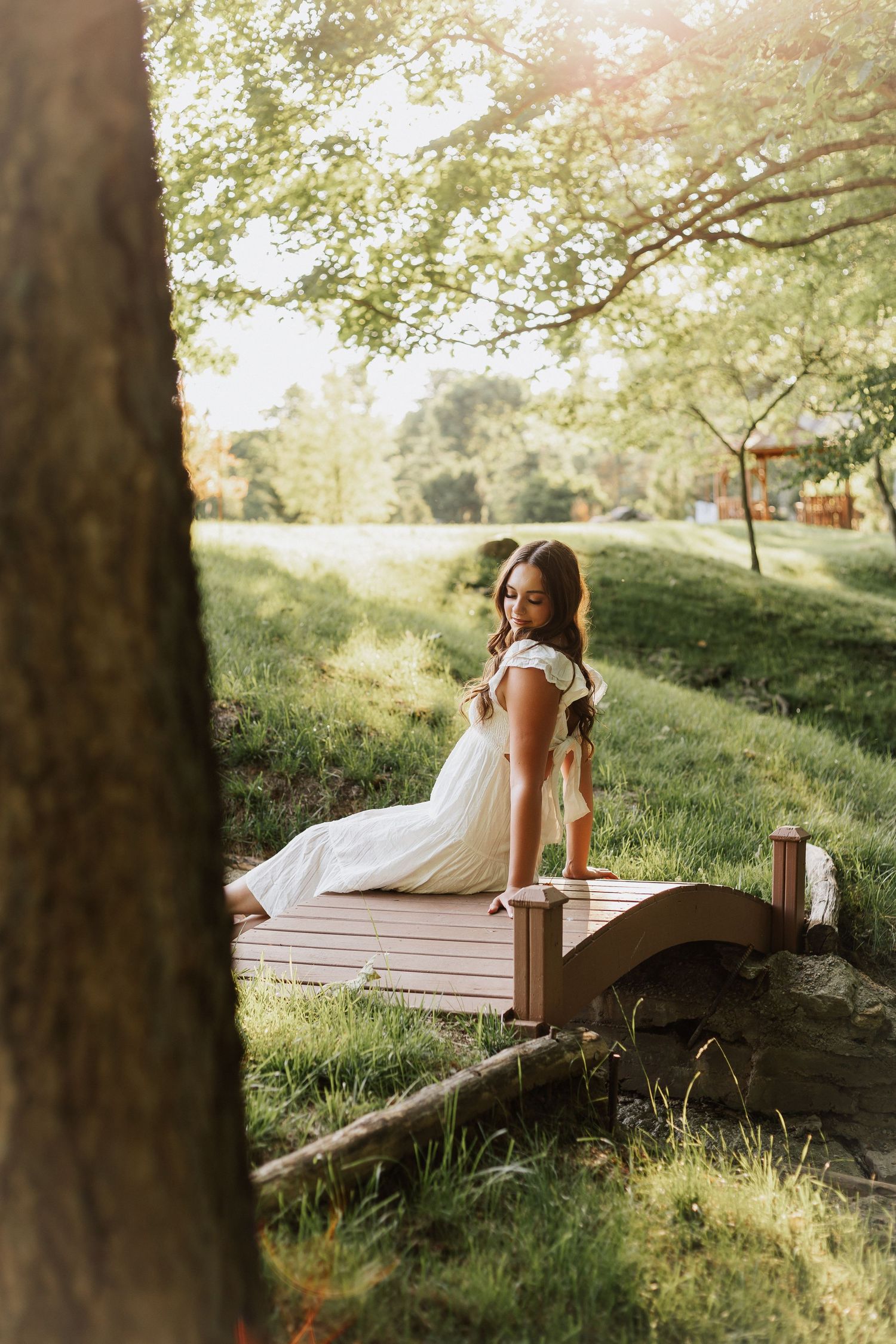 Romantic sunset portrait on a wooden deck surrounded by lush greenery.