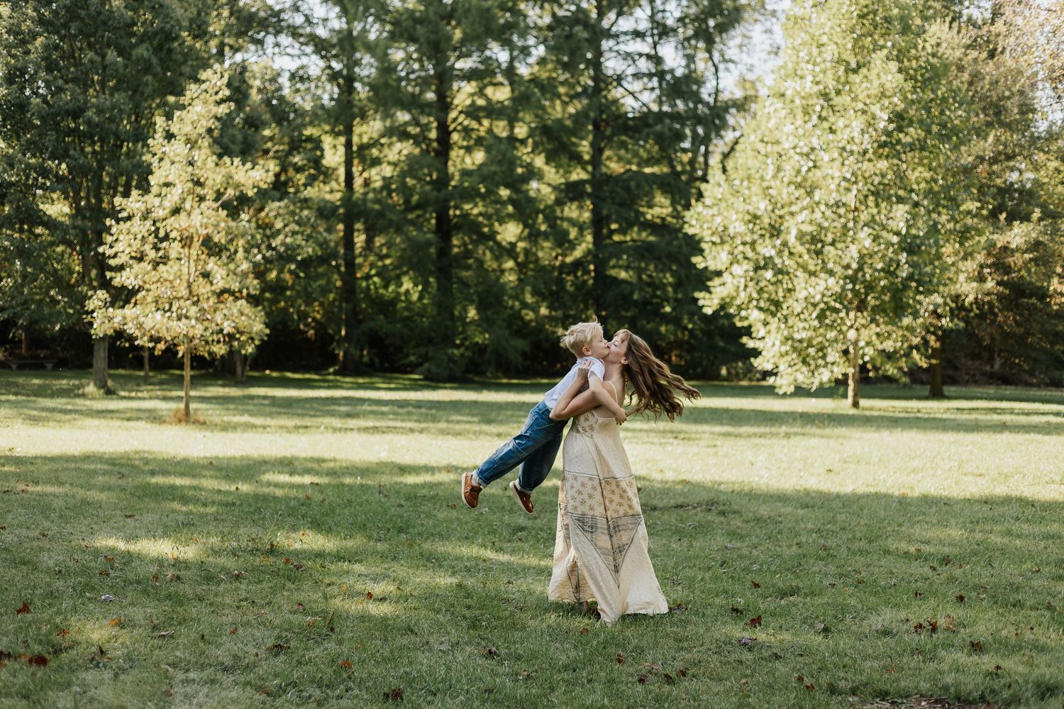 People enjoying a playful moment in a grassy field on a sunny day.