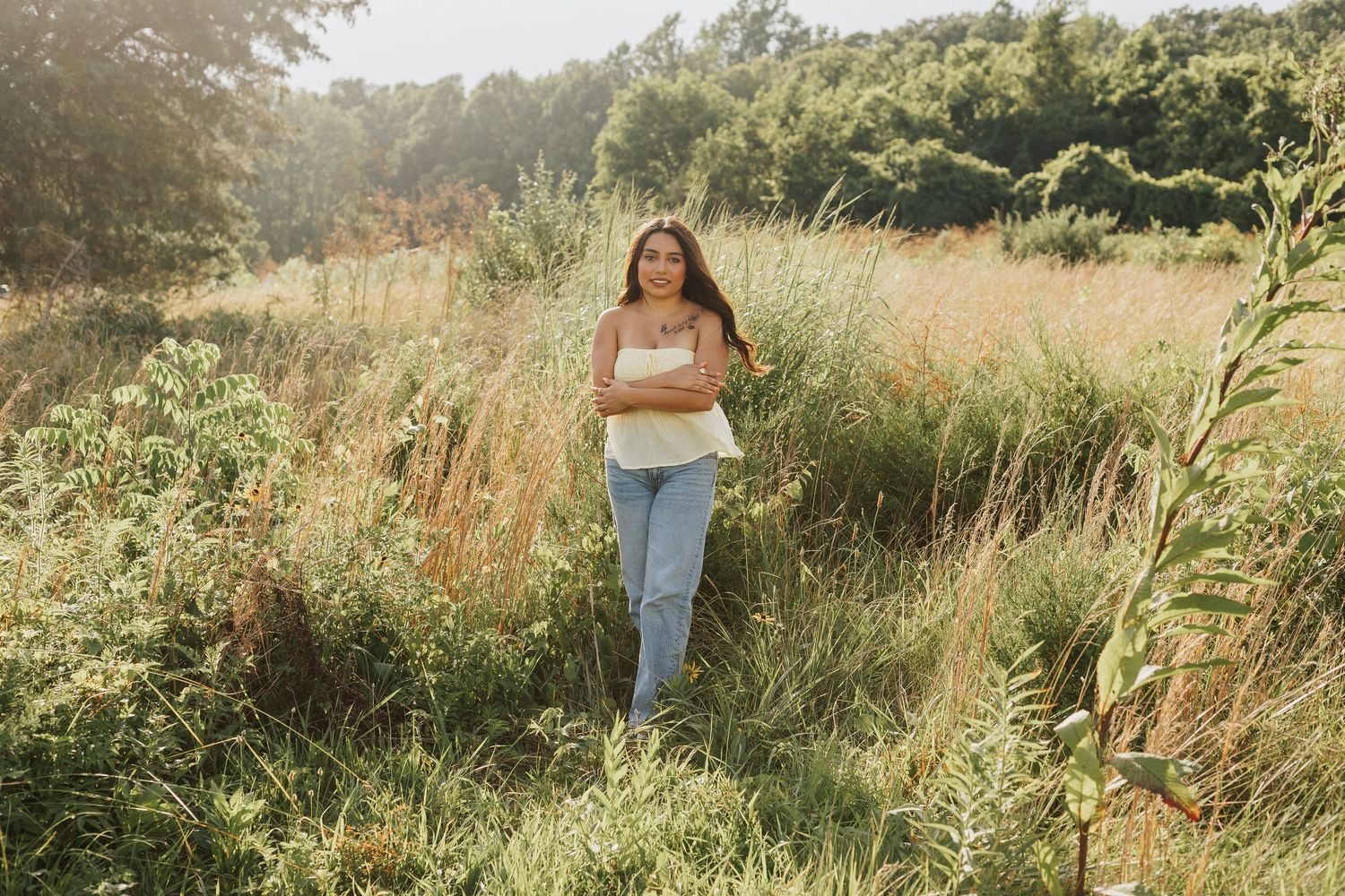Casual outdoor photoshoot in a field of tall grass and trees.
