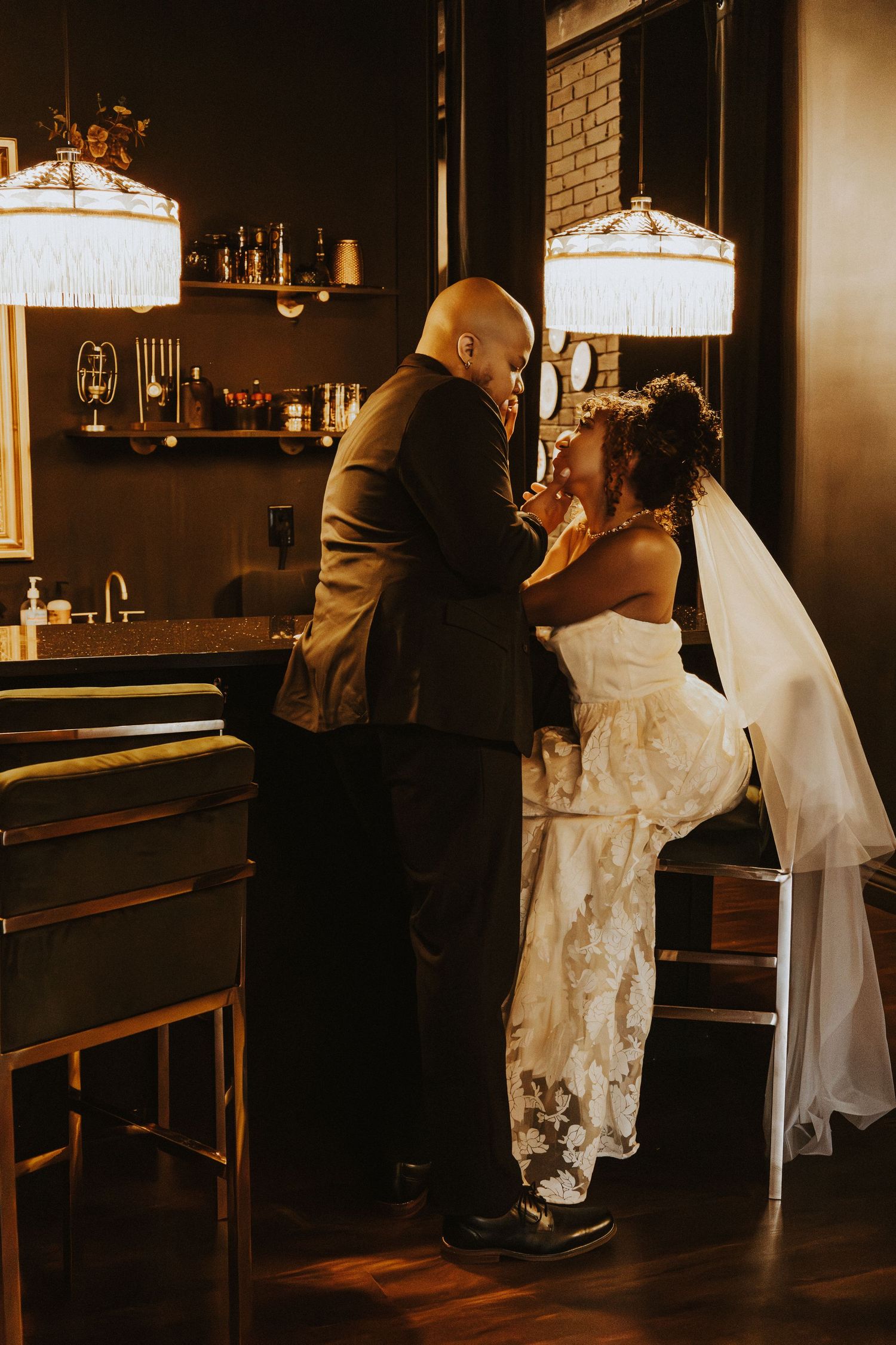 Romantic dance moment under vintage pendant lights in intimate venue setting.