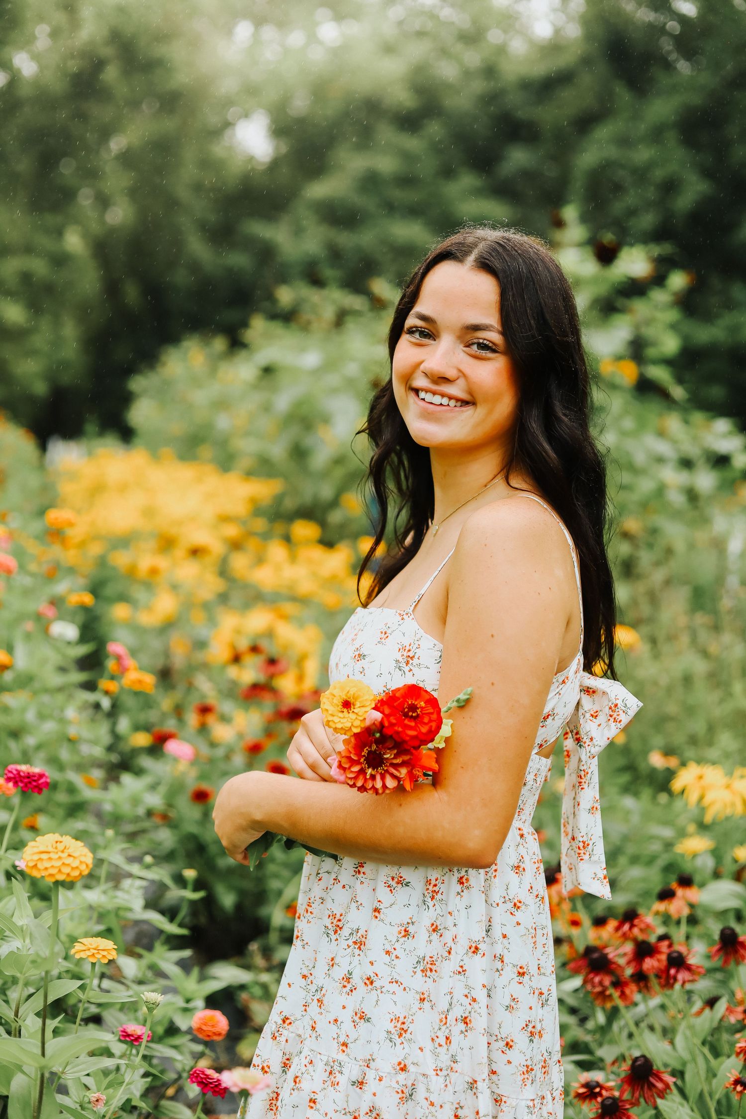 A candid moment captured in a wildflower garden with bright zinnias and marigolds in bloom.
