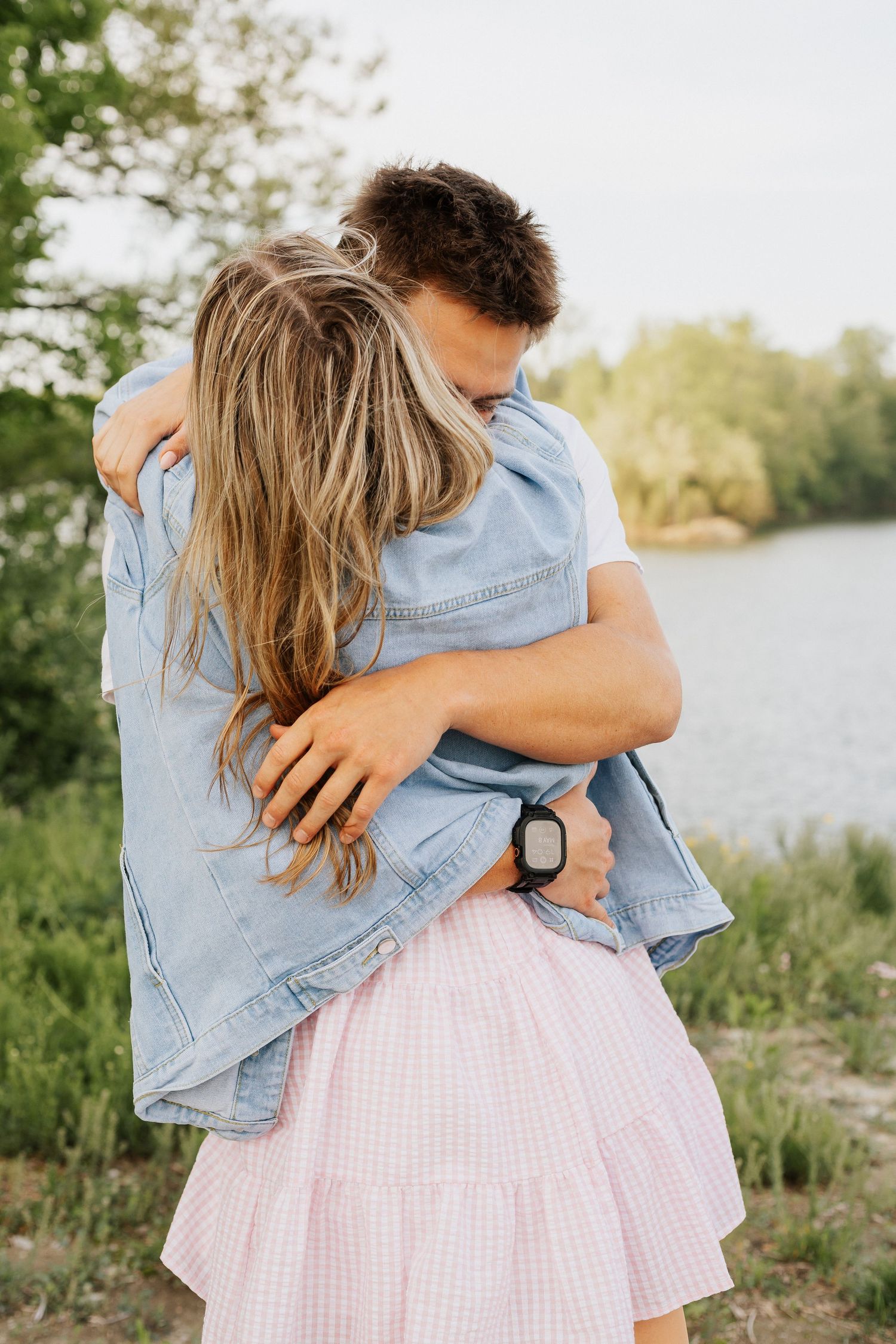 A pink gingham skirt and denim jacket against a natural outdoor setting.