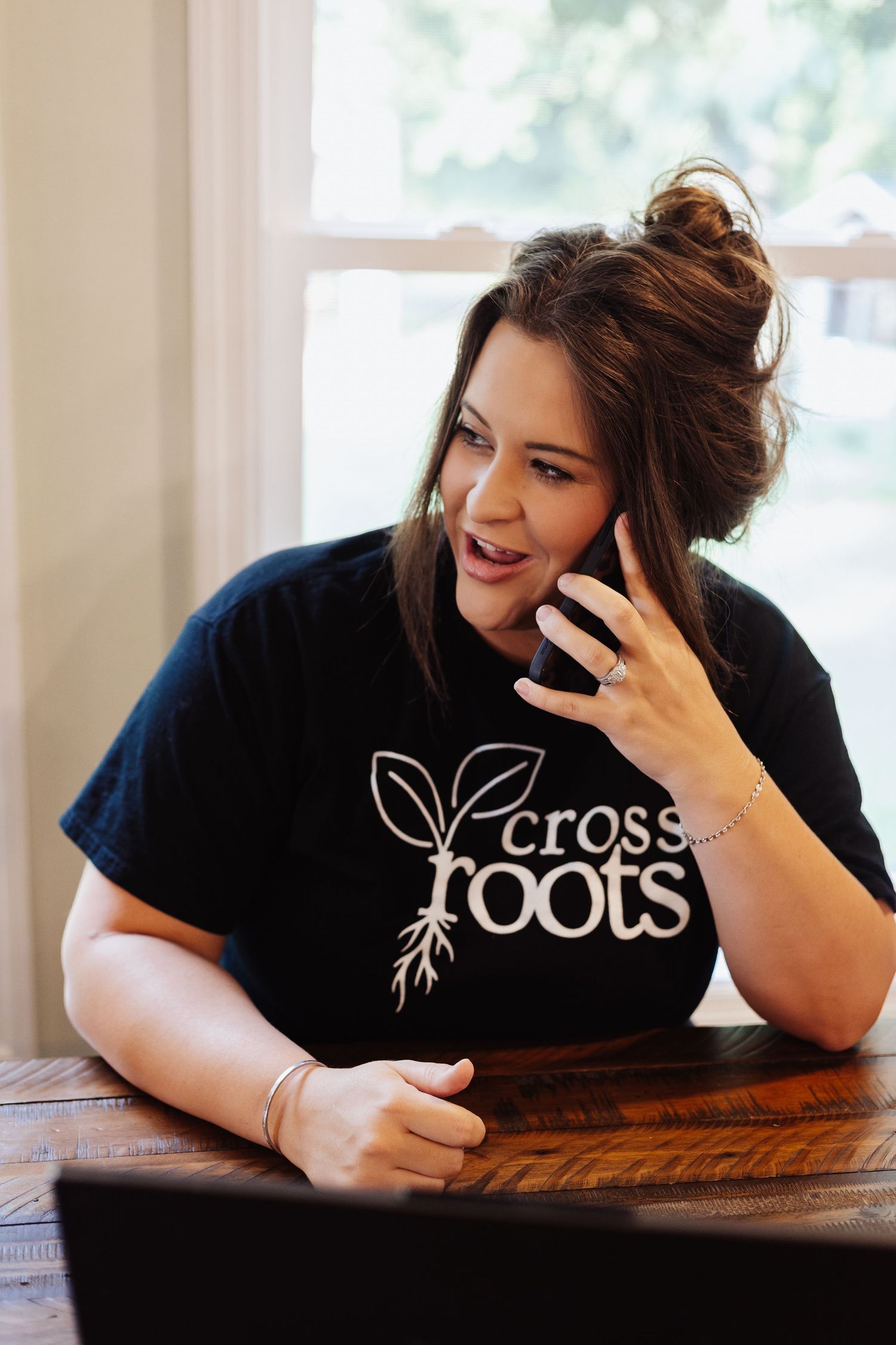 Series of candid shots showing person working at desk wearing company branded shirt.