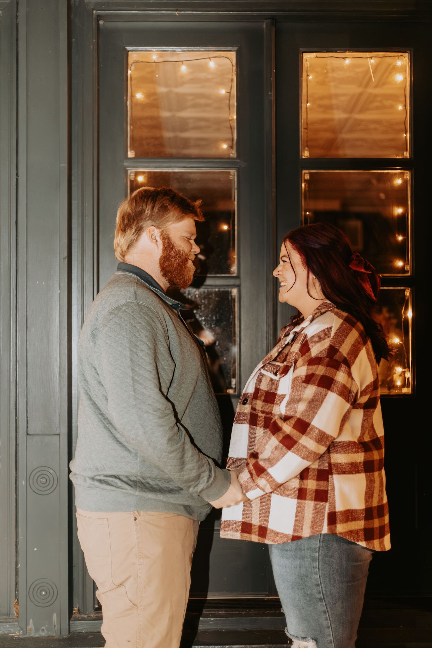 Series of romantic poses against a dark window with warm lighting and vintage frames.