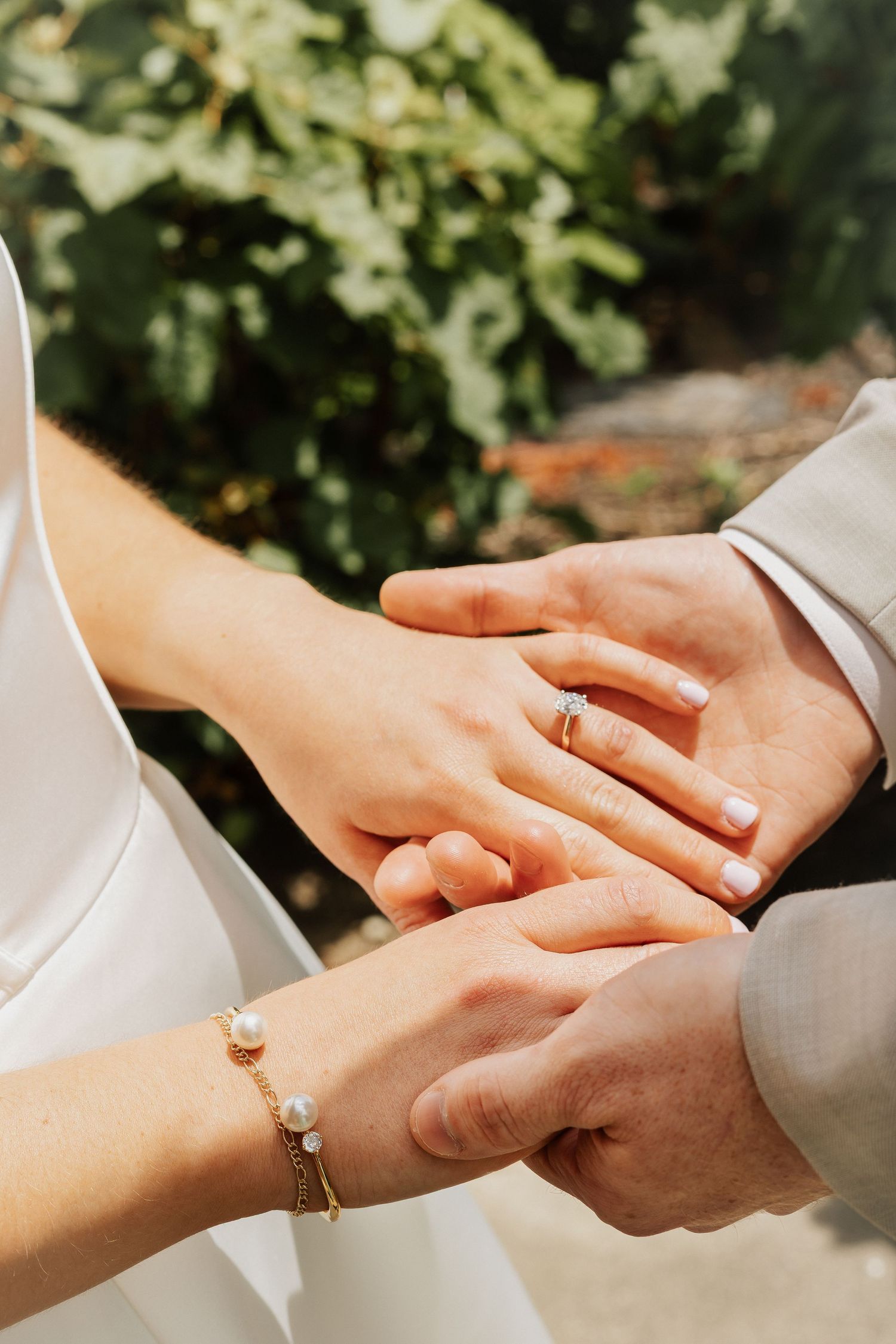 Close-up of hands exchanging wedding rings during ceremony.