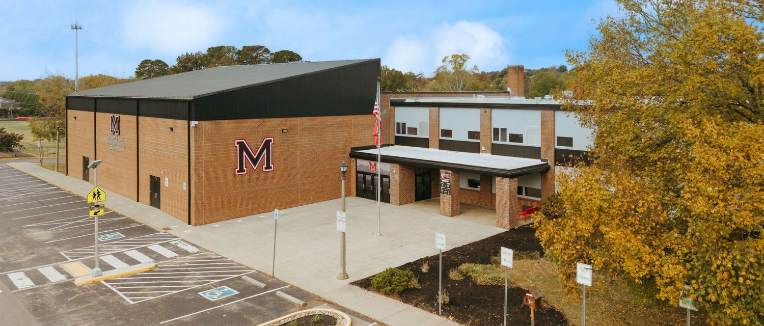Aerial view of Maryville school campus buildings and parking lot on sunny autumn day.