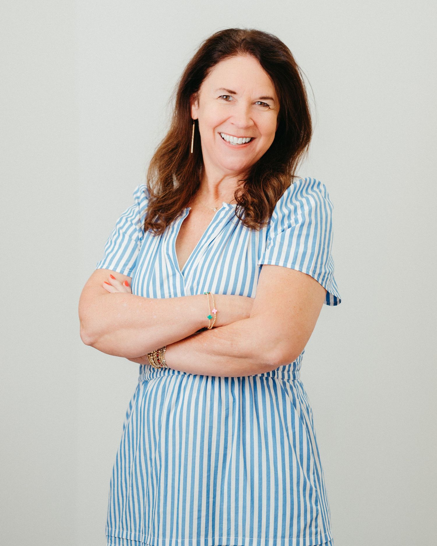 Portrait series in blue striped shirt showing confident poses against light background.