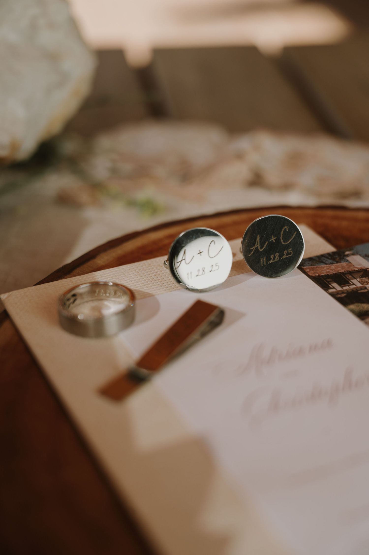 Wedding rings and personal accessories arranged on white paper.